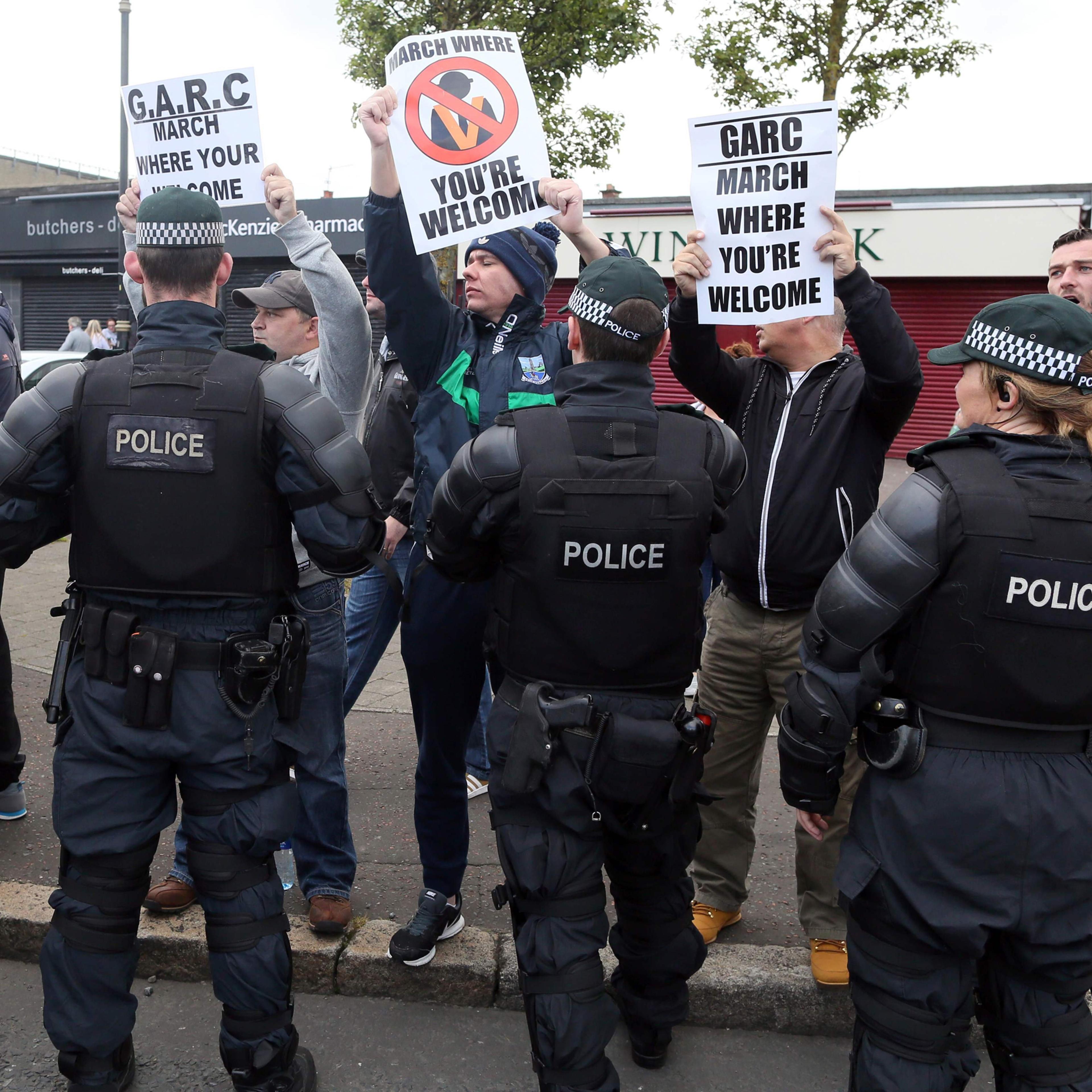 The police keep Nationalist protestors away from a Loyalist feeder parade as it passes the Nationalist Ardoyne shops on its way to join the main 12th July celebrations inn Belfast, Northern Ireland on July 12, 2016.