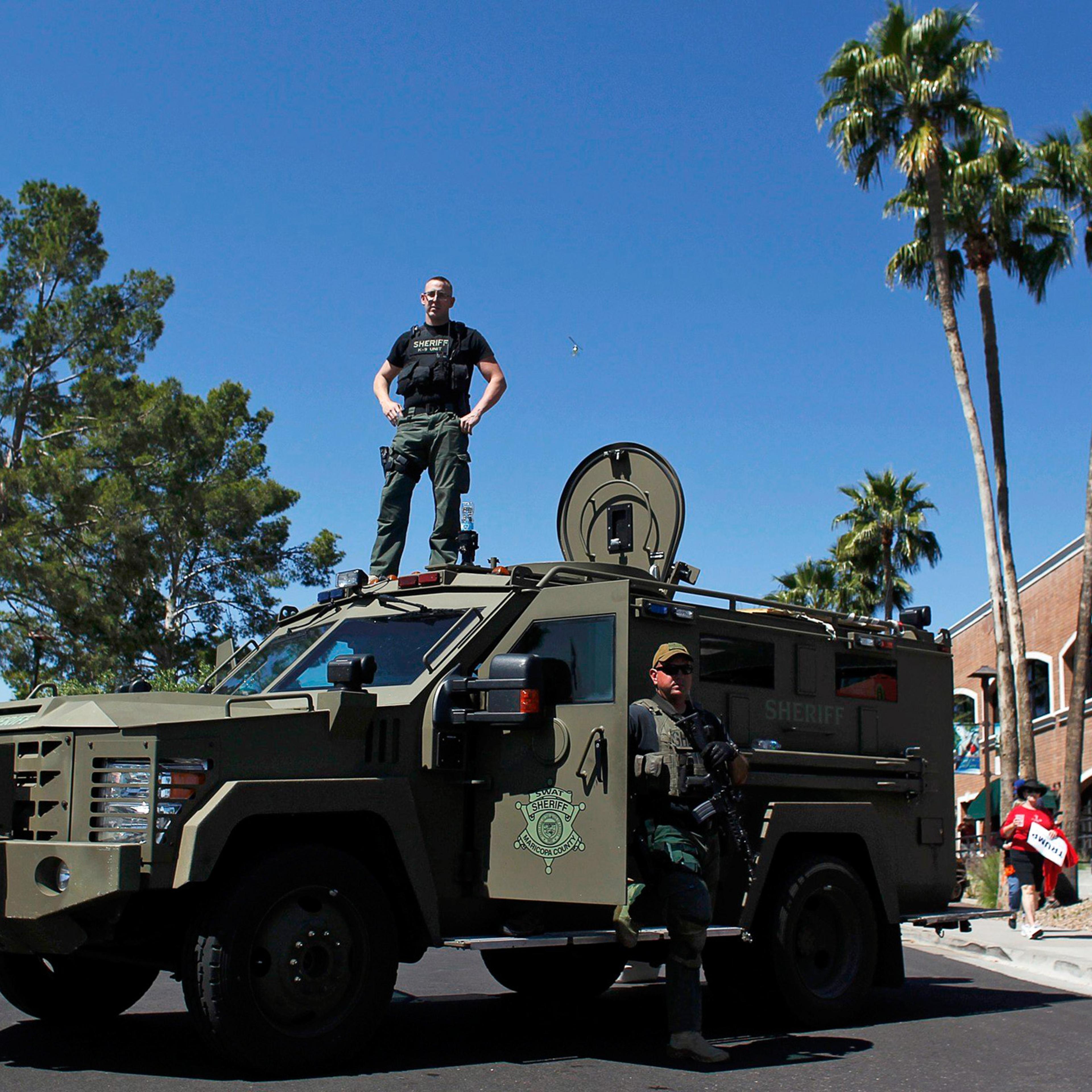 Maricopa County, Arizona police SWAT team stand guard with an armored vehicle outside a campaign rally for Republican presidential candidate Donald Trump in Fountain Hills, Ariz. on March 19.