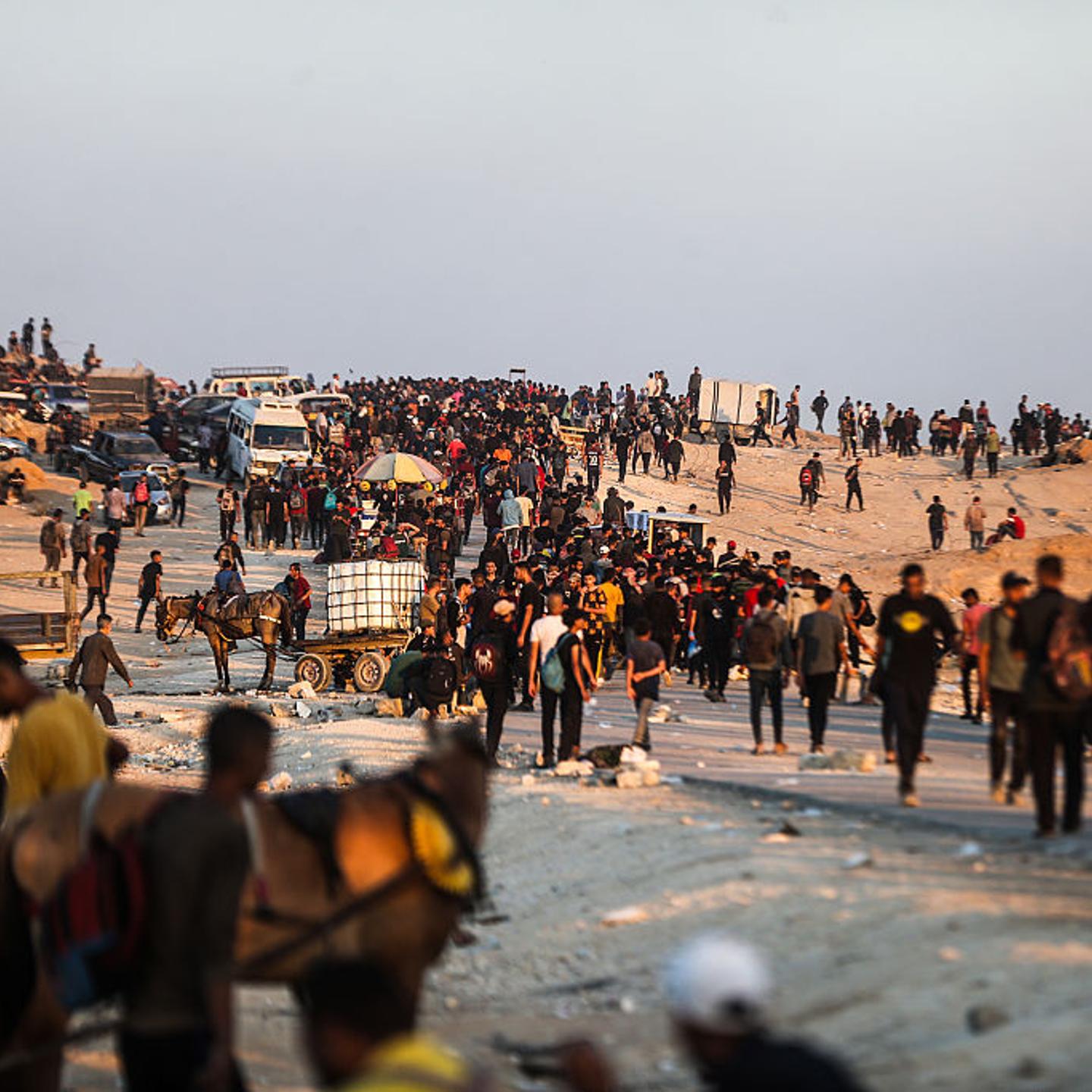 Palestinians gather around central Gaza, awaiting for aid to enter from a non-GHF distribution site on July 2.