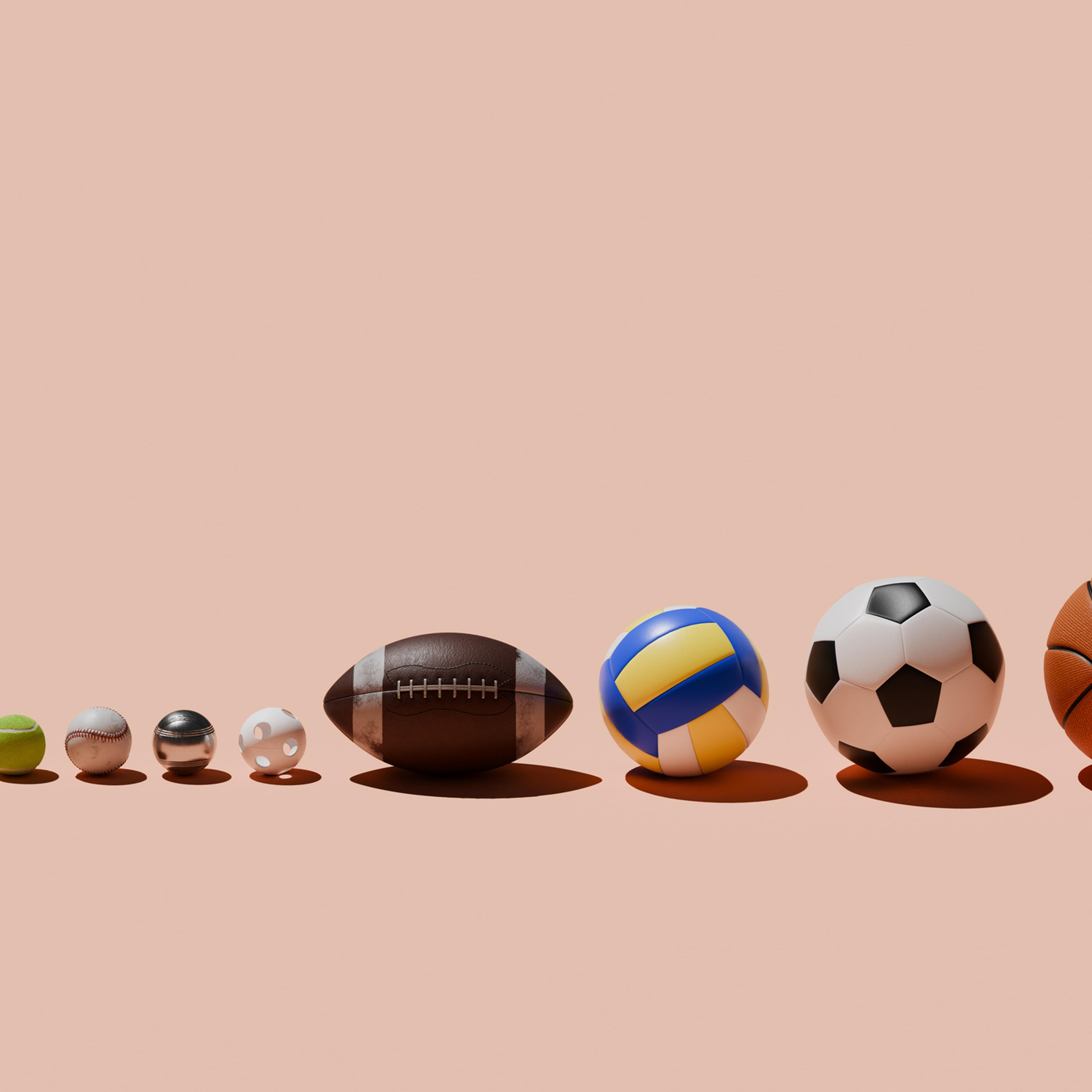 Various sports balls in a row
