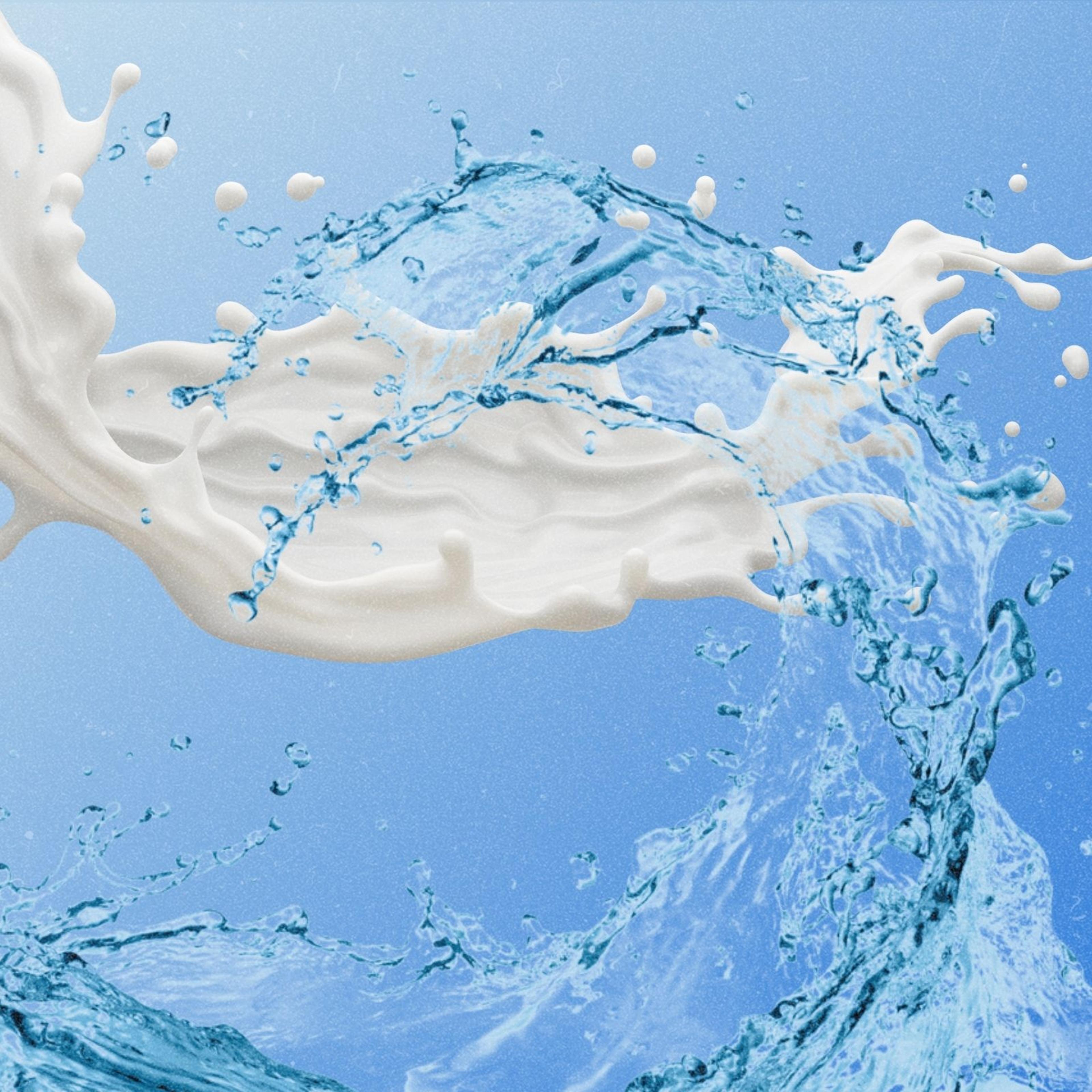 A wave of milk and a wave of water splashing across the screen