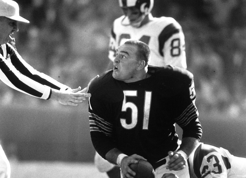 Dick Butkus appears agitated after recovering a fumble against the Rams during his rookie season with the Bears in 1965.