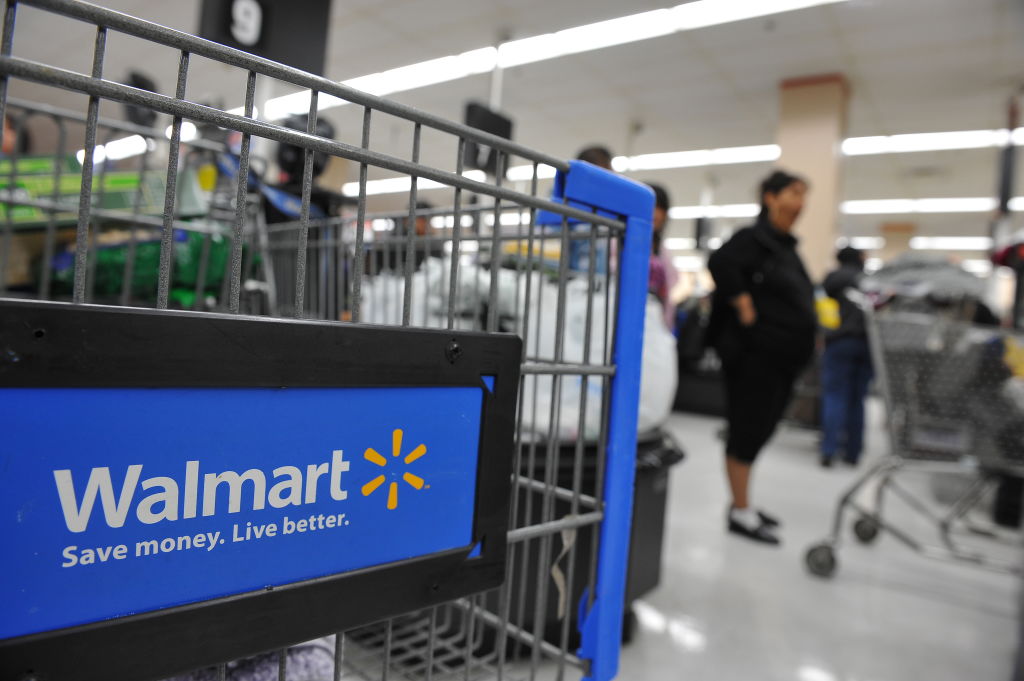 Shoppers wait in line to pay for their purchases at a Walmart store in Los Angeles, California on November 24, 2009.