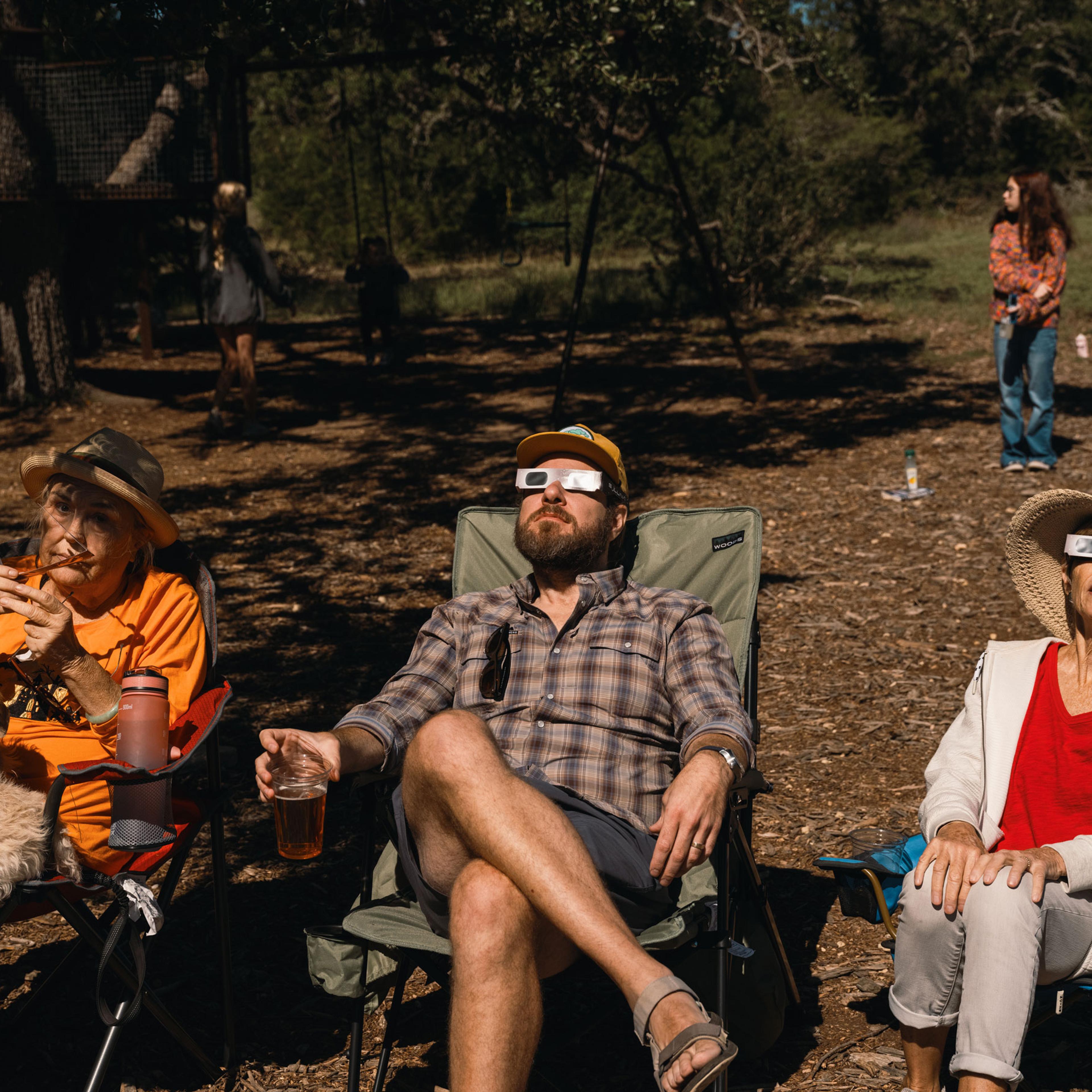 Spectators wear solar viewing glasses during a solar eclipse in Driftwood, Texas, on Oct. 14, 2023.