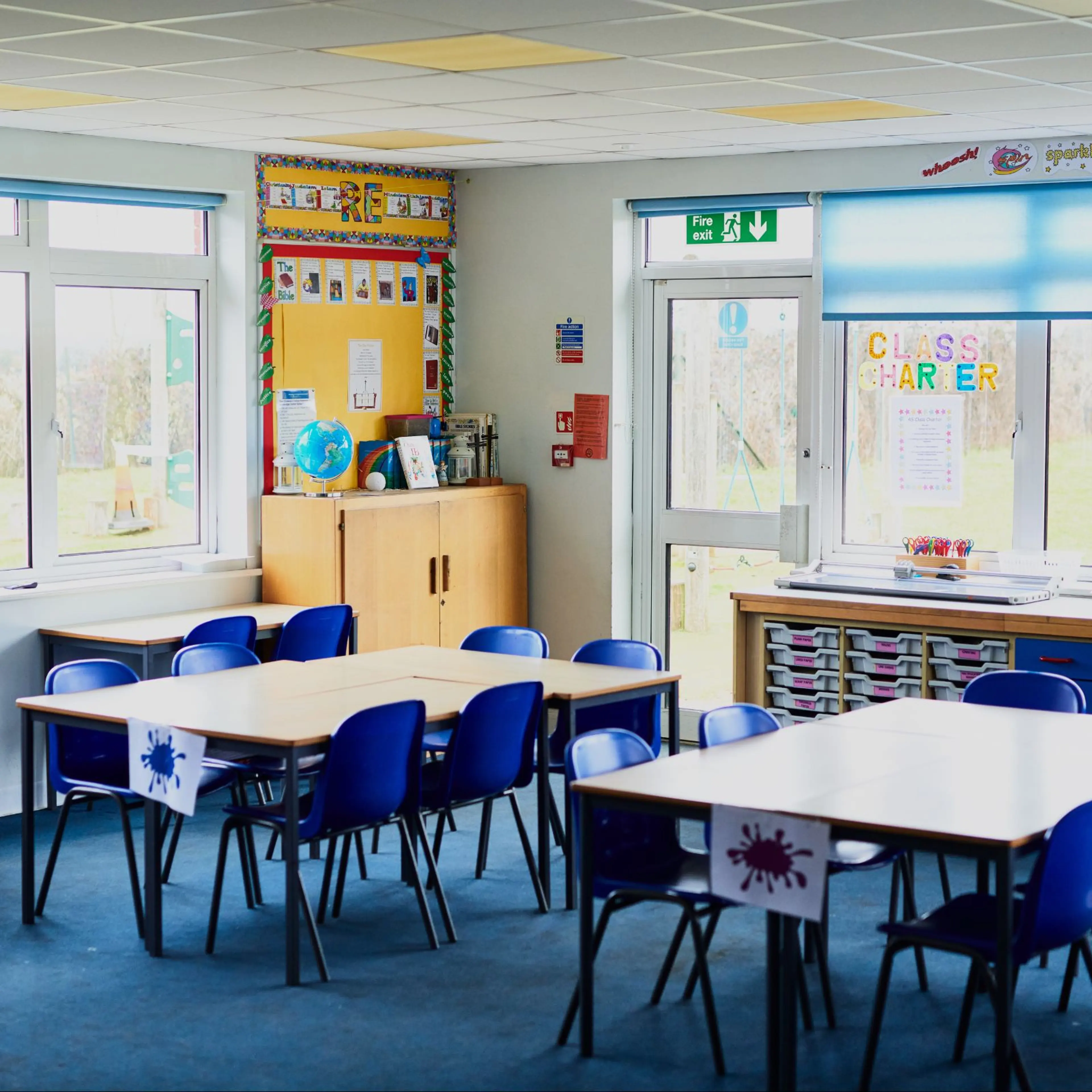 Tables and chairs arranged in a school class room.