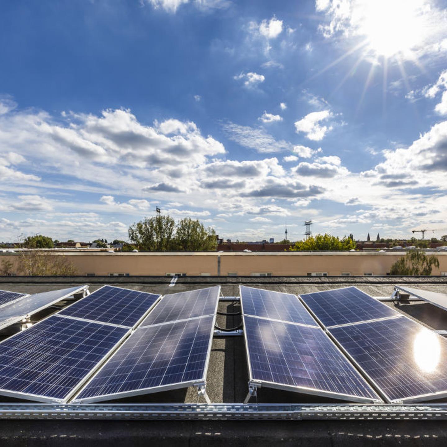 Solar panels sit on the roof of an apartment block in Germany.