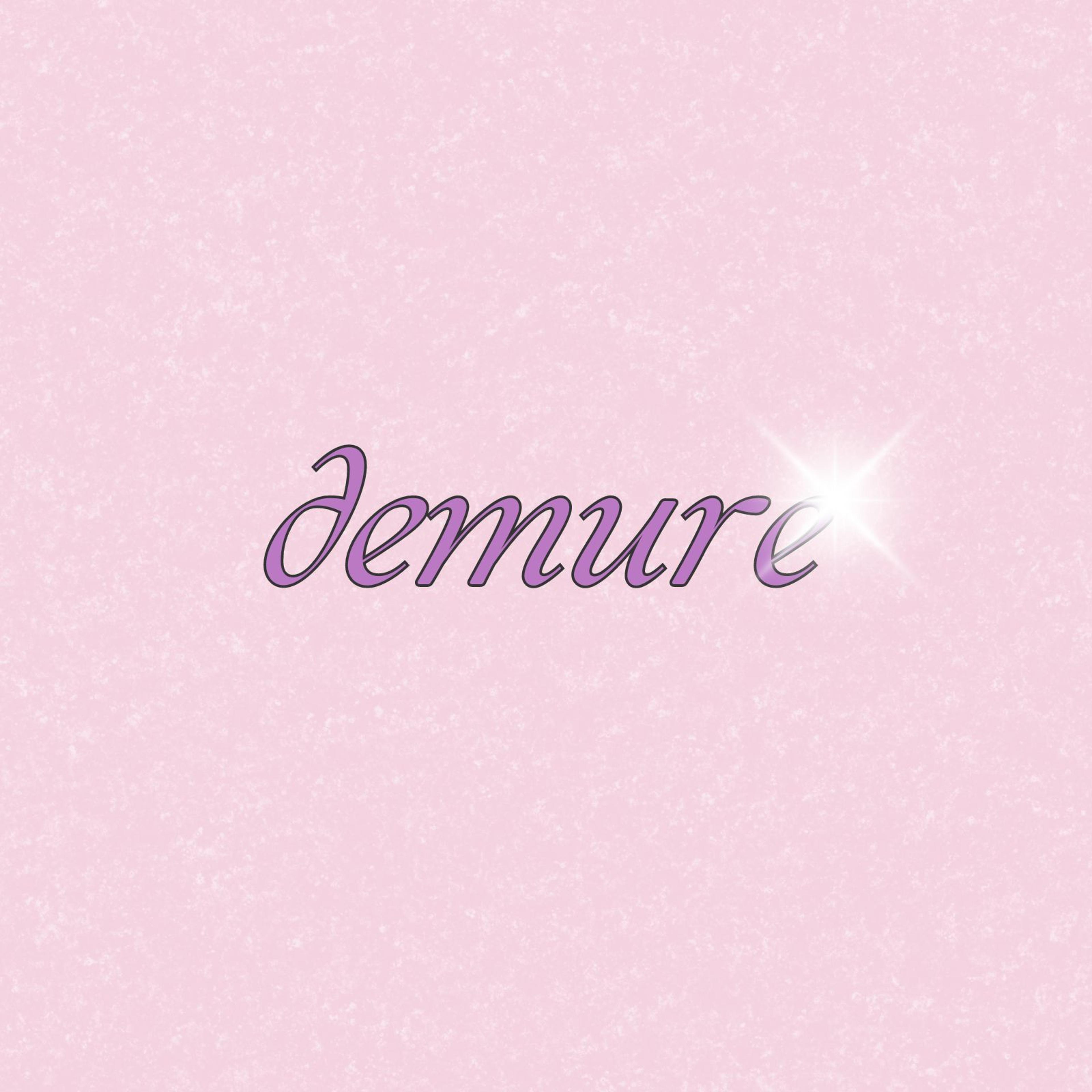 The word demure in pink on a light pink background