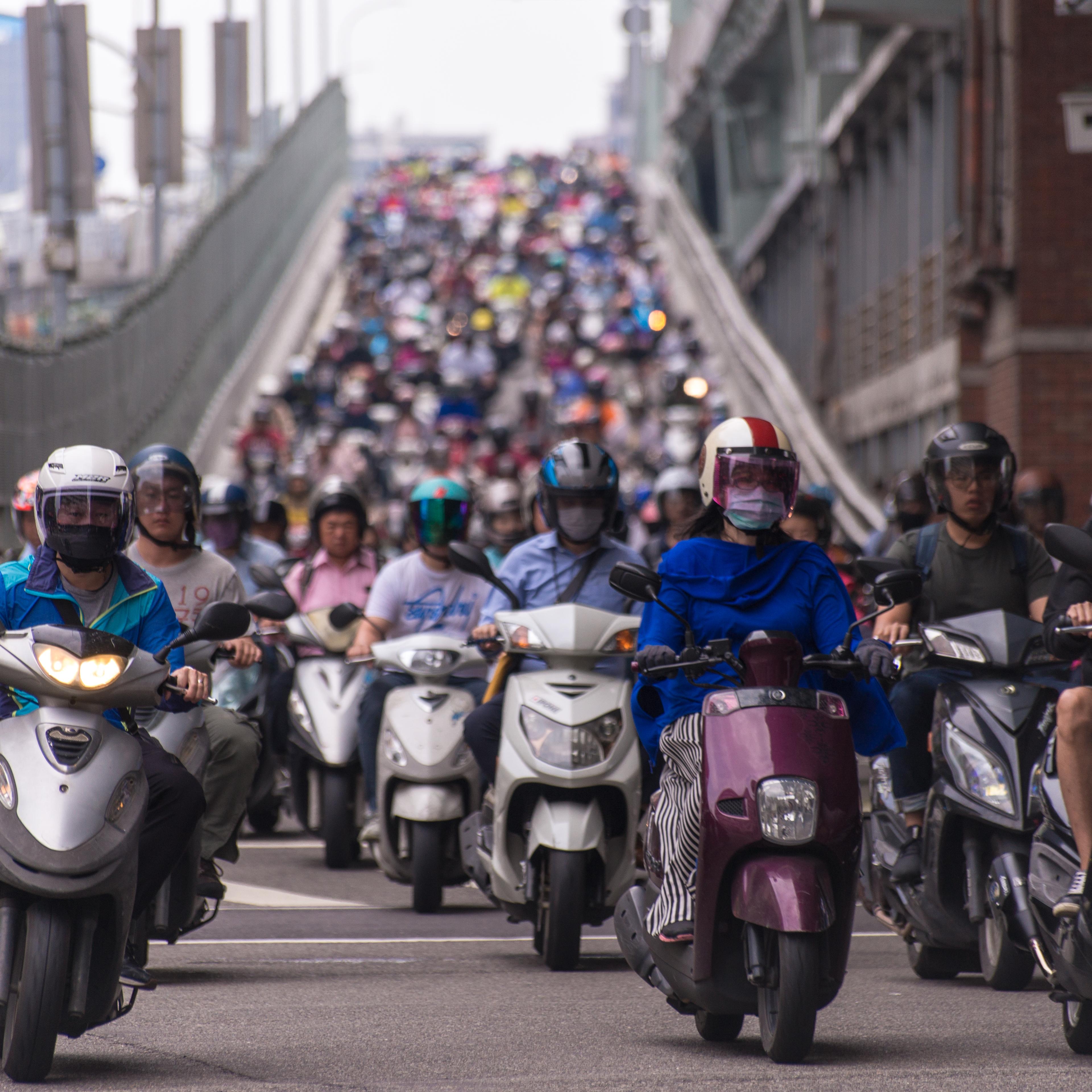 Taipei, Taiwan - June 13, 2018: Motorcycles go down the Taipei bridge during rush hour in the morning.