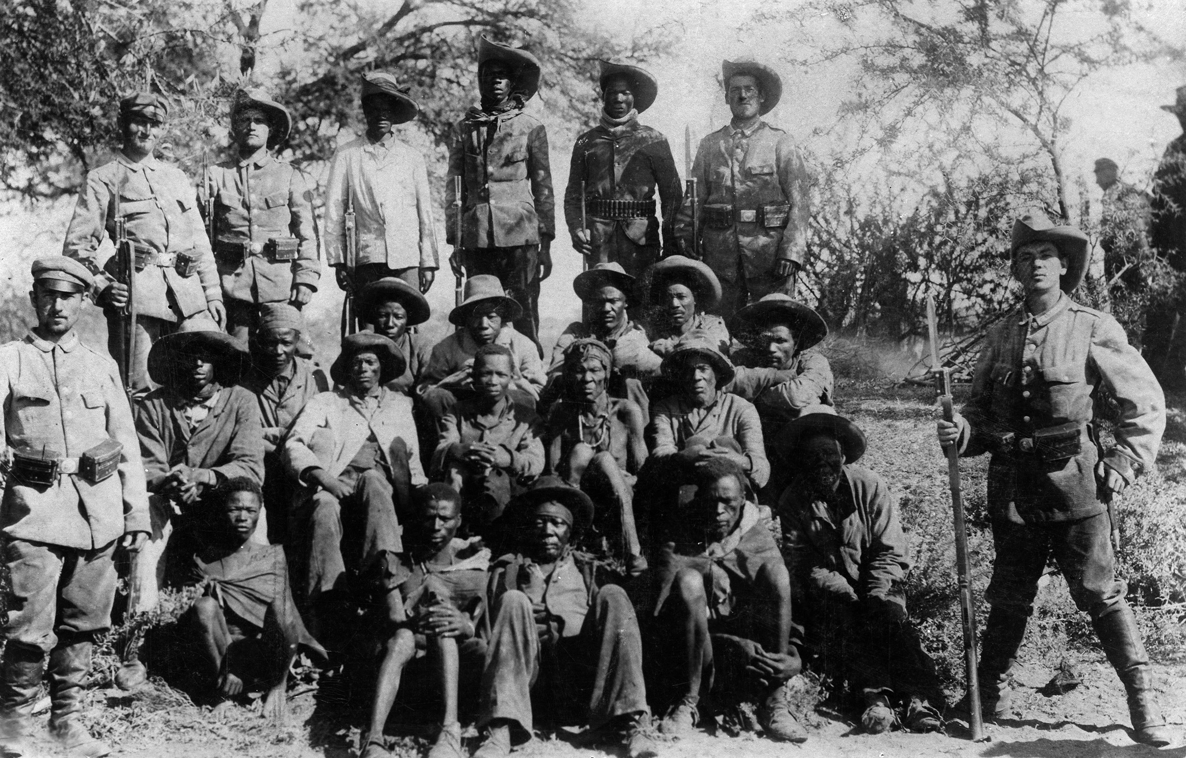 German soldiers pose with captured Nama - Hottentots, circa 1905.