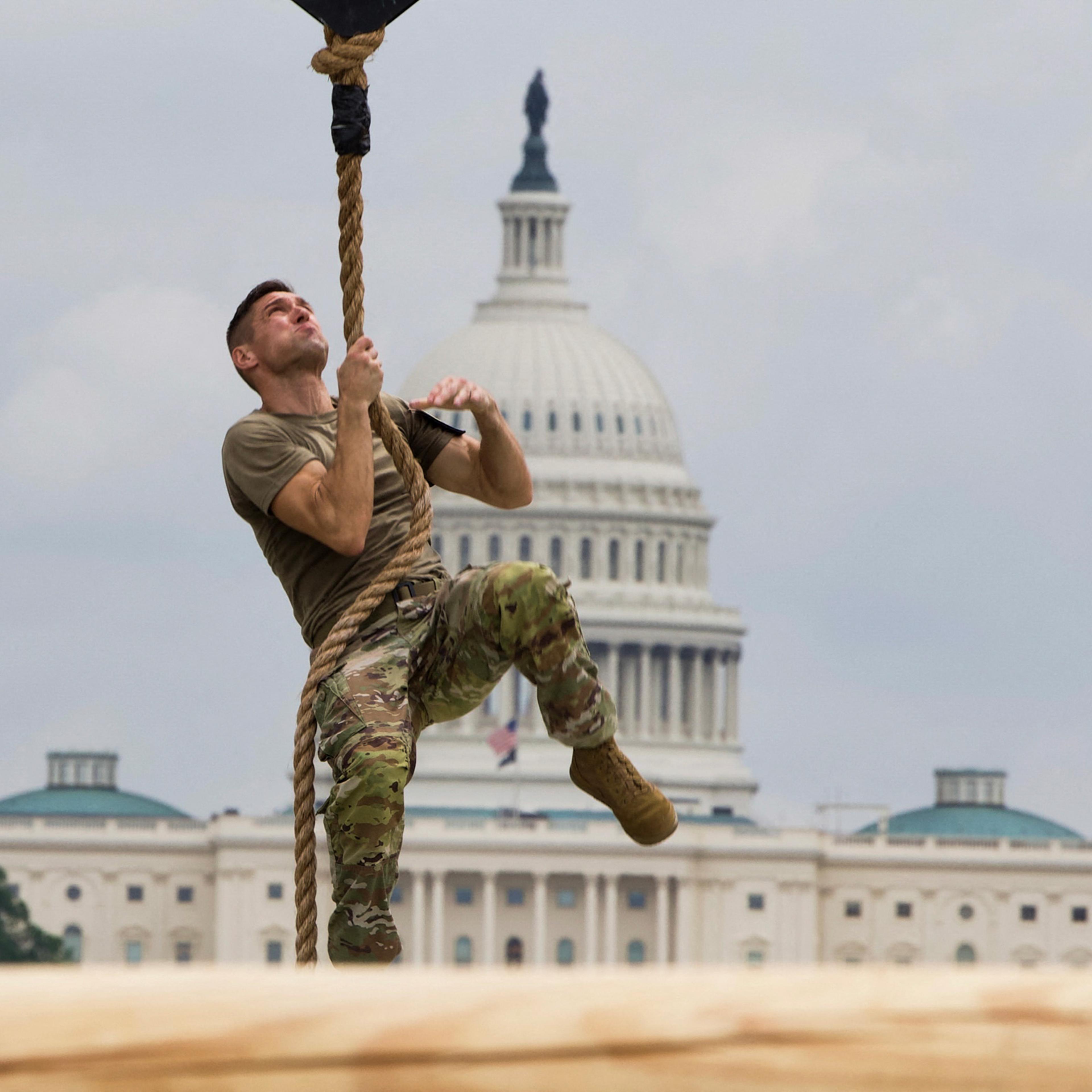 A U.S. soldier climbs a rope as he participates in a fitness competition during the Army 250th Anniversary Parade on the National Mall in Washington, D.C. on June 14, 2025.