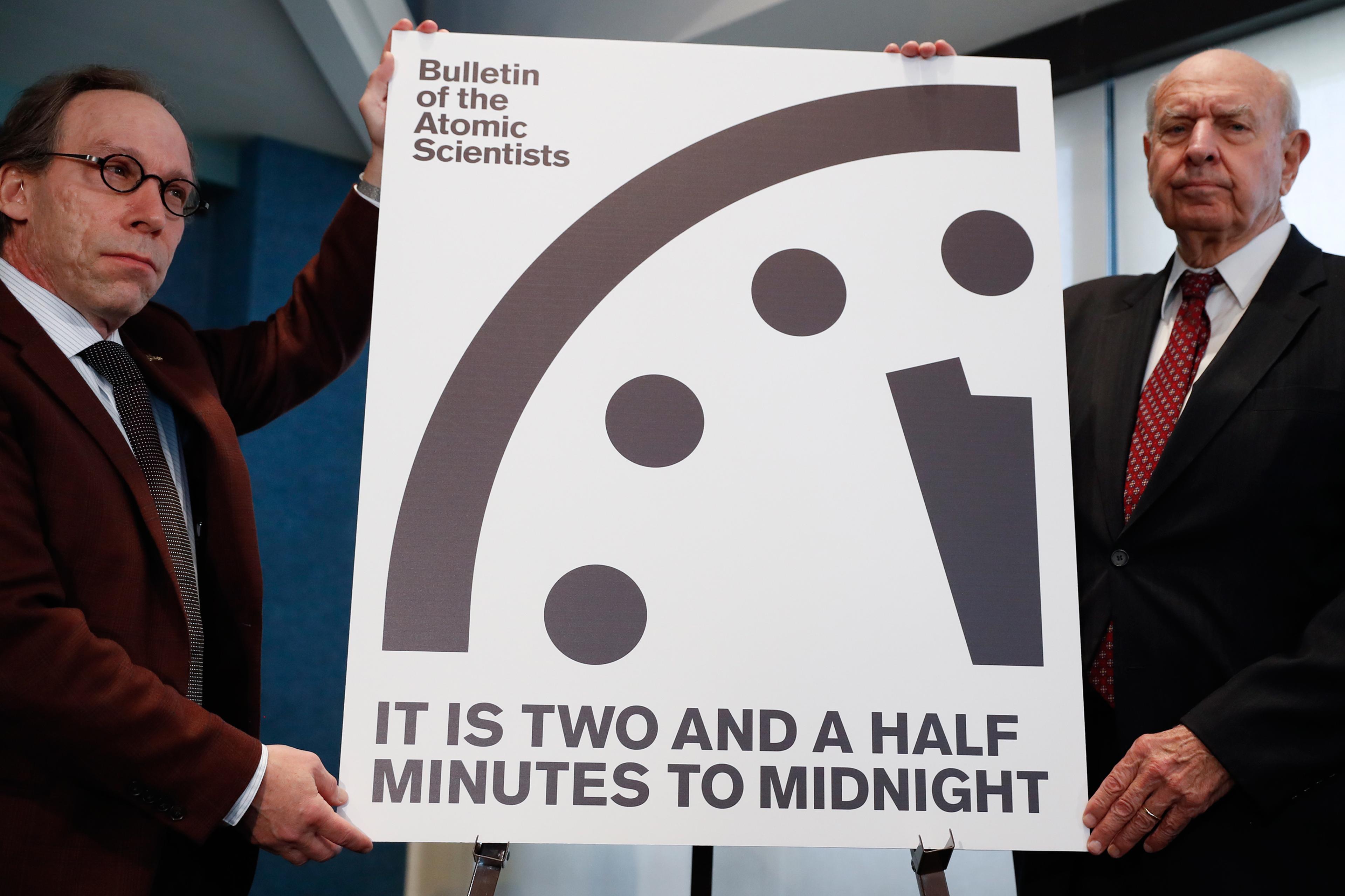 Lawrence Krauss, theoretical physicist, chair of the Bulletin of the Atomic Scientists Board of Sponsors, left, and Thomas Pickering, co-chair of the International Crisis Group, display the Doomsday Clock during a news conference the at the National Pres