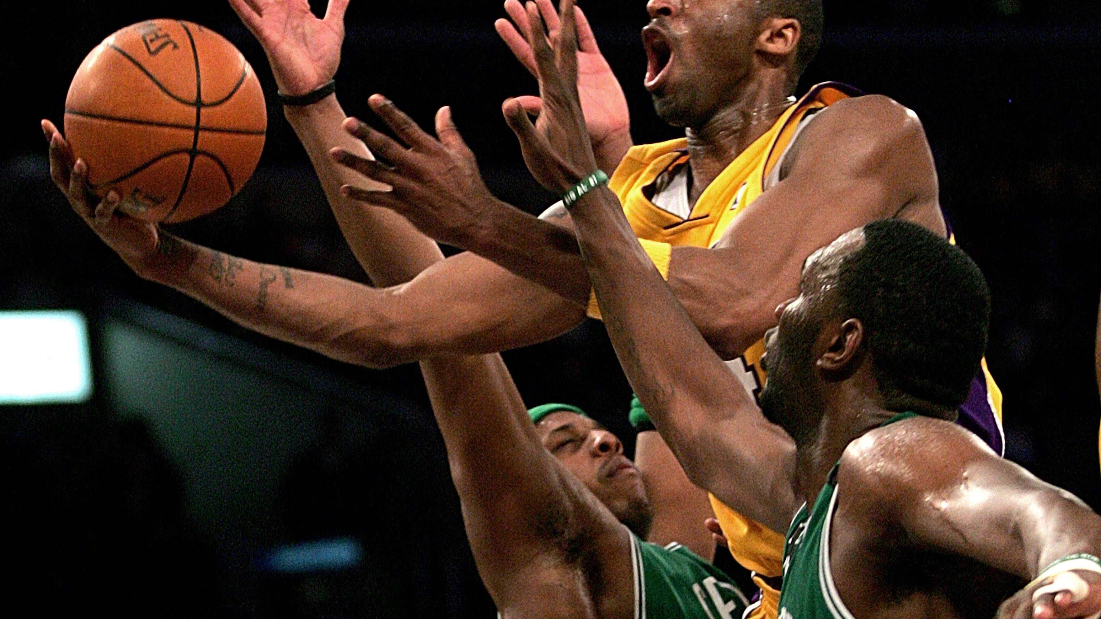 Kobe Bryant goes up for a shot between the Boston Celtics' Paul Pierce and Al Jefferson