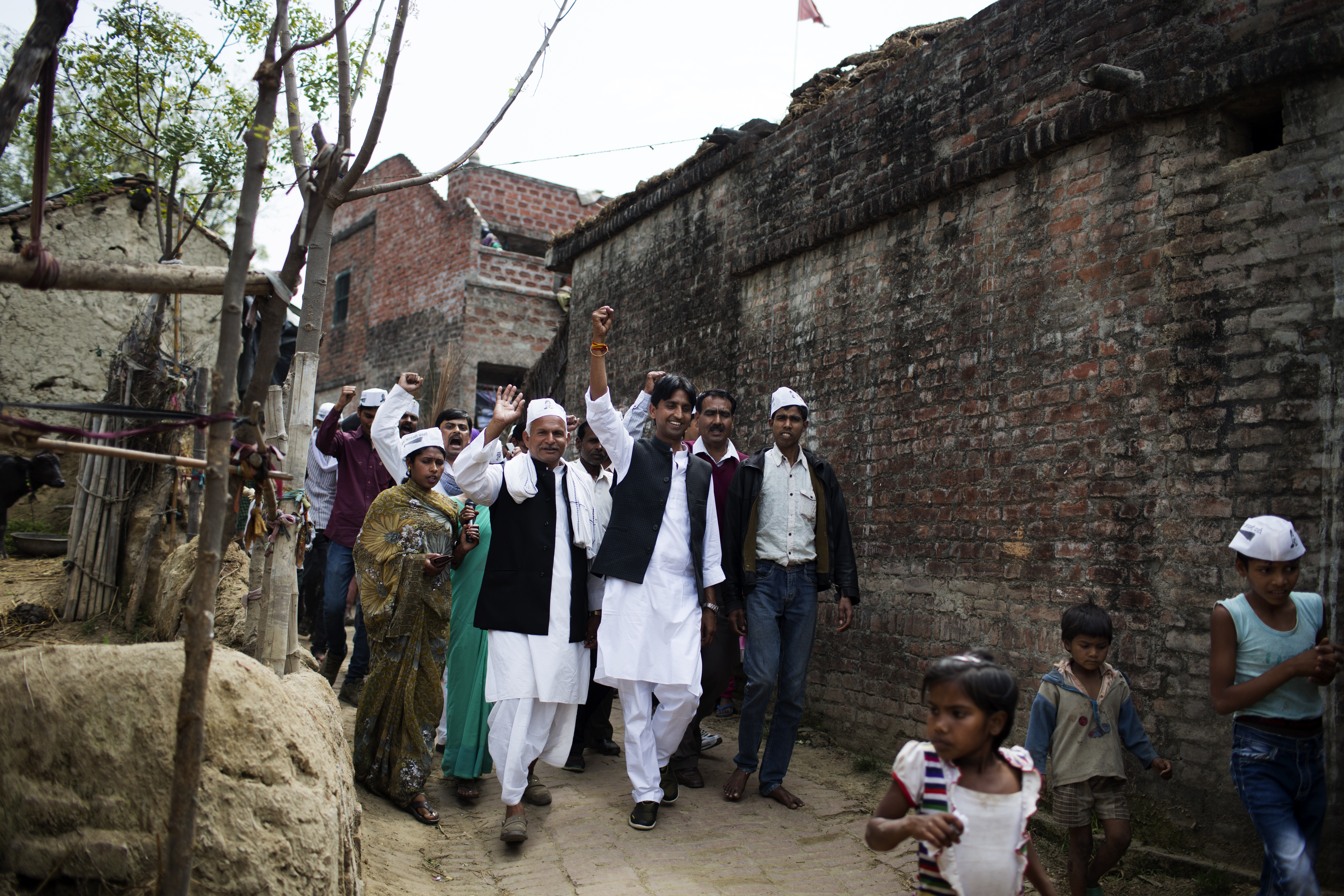 AAP candidate Kumar Vishwas, front center, arm raised high, campaigns in Amethi district