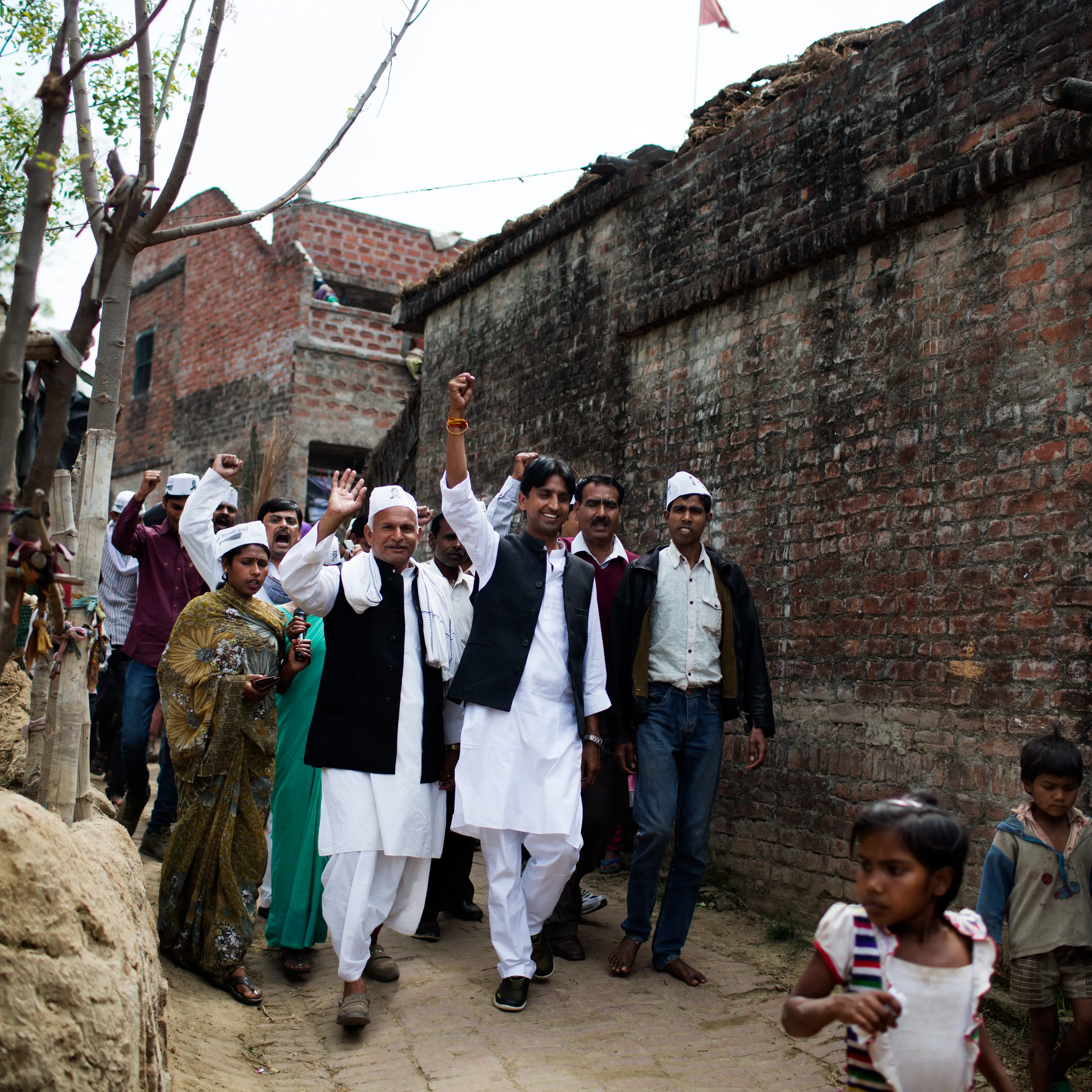AAP candidate Kumar Vishwas, front center, arm raised high, campaigns in Amethi district
