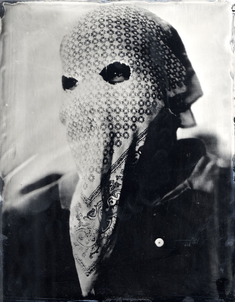 A masked member of the 'auto defensa' committee in Ayutla de los Libres, a small pueblo in the La Costa Chica region of Guerrero state, Mexico. Ambrotype glass plate, 2013.
