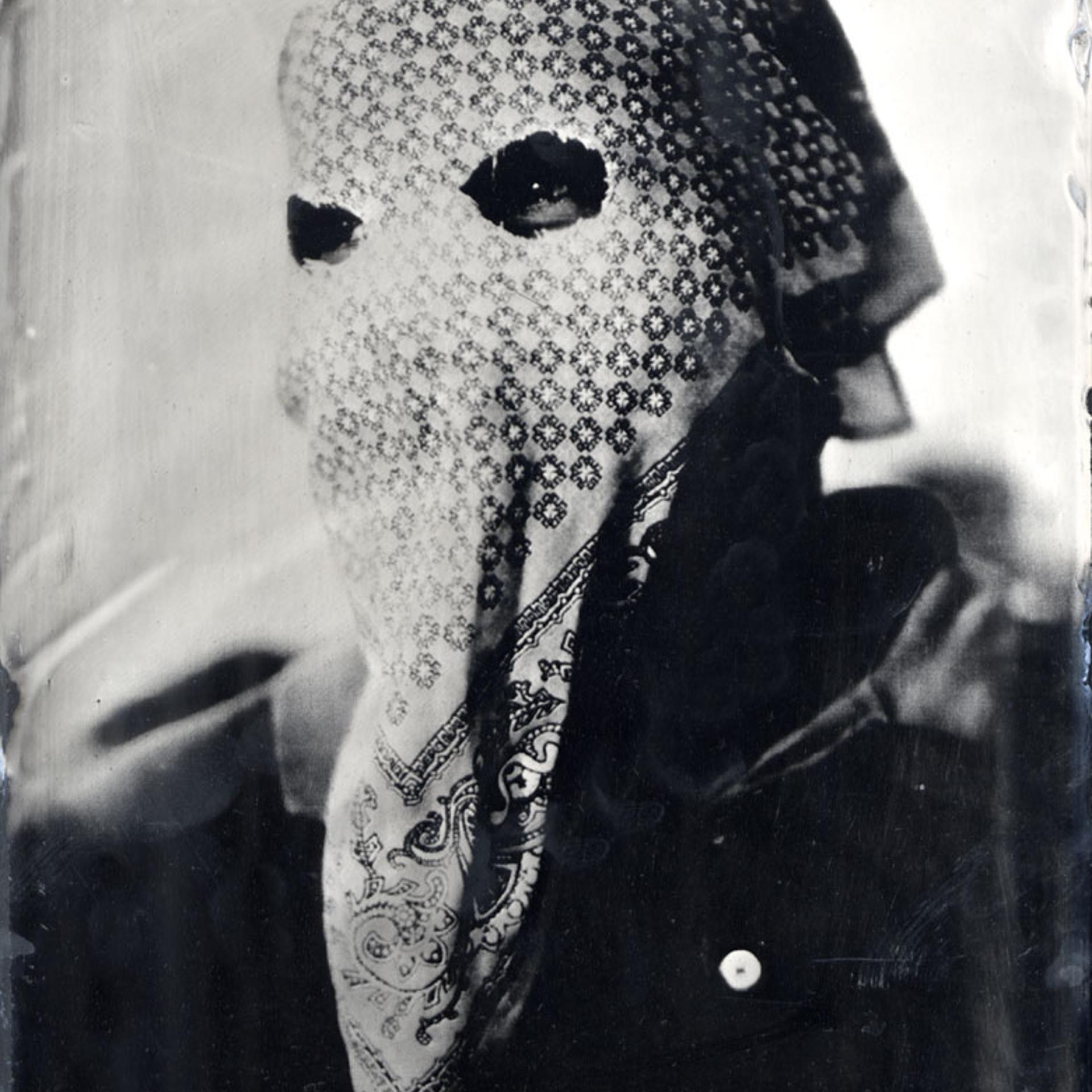 A masked member of the 'auto defensa' committee in Ayutla de los Libres, a small pueblo in the La Costa Chica region of Guerrero state, Mexico. Ambrotype glass plate, 2013.