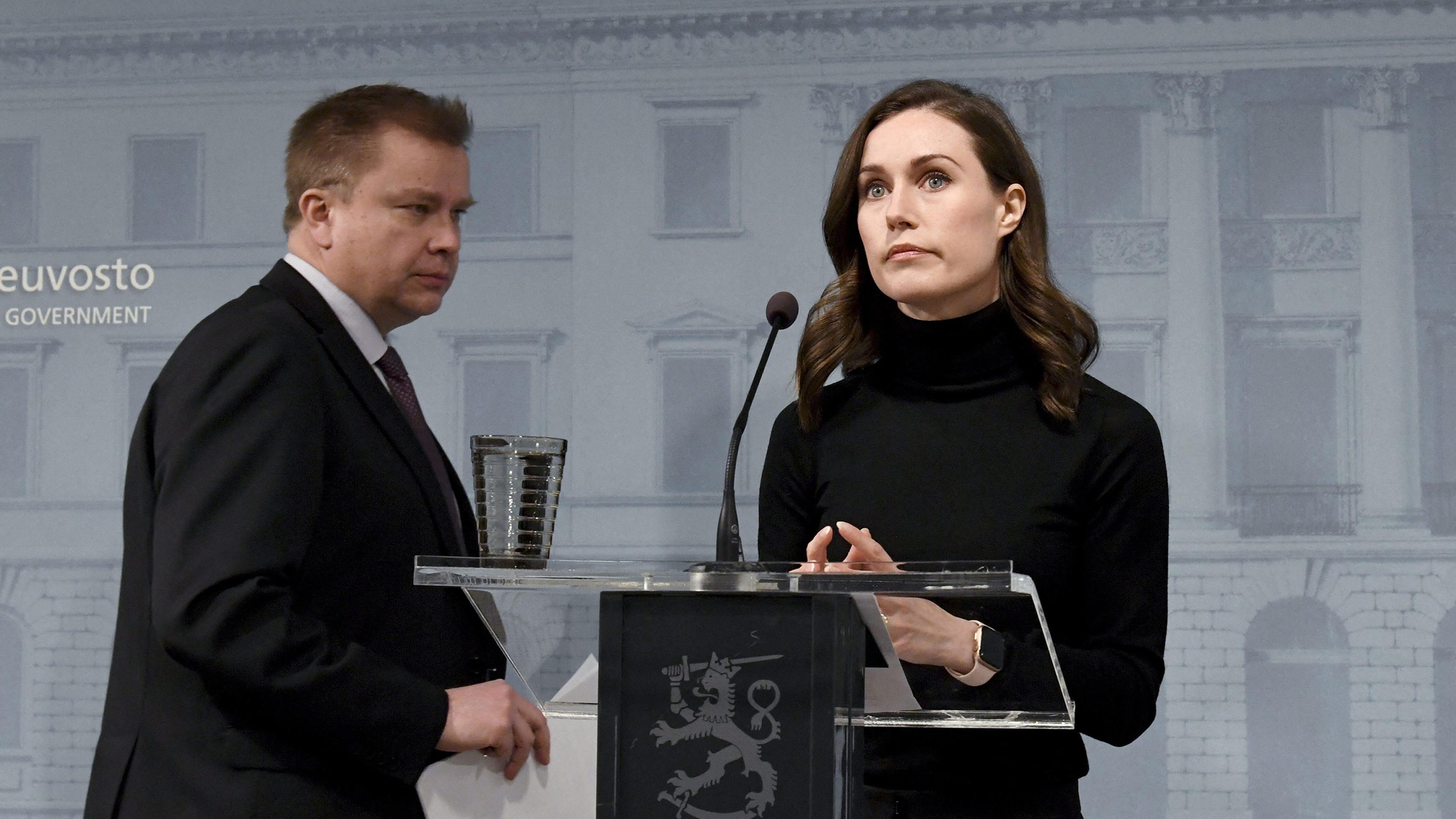 Finland's Prime Minister Sanna Marin, right, and Defense Minister Antti Kaikkonen arrive to address a press conference after the decision to supply arms to Ukraine, in Helsinki, Finland, on Feb. 28, 2022.