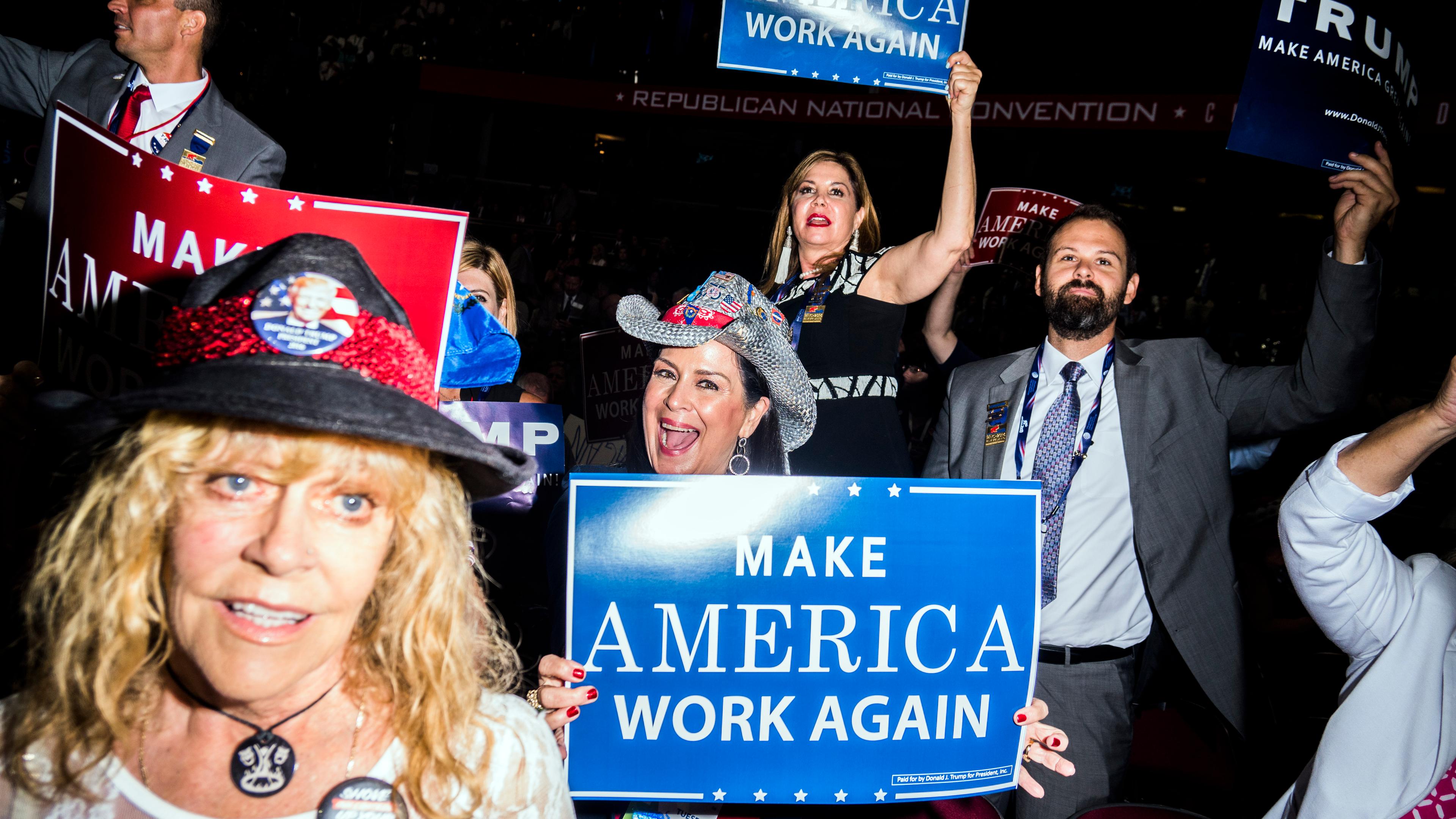 Attendees hold signs at the Republican National Convention in Cleveland.