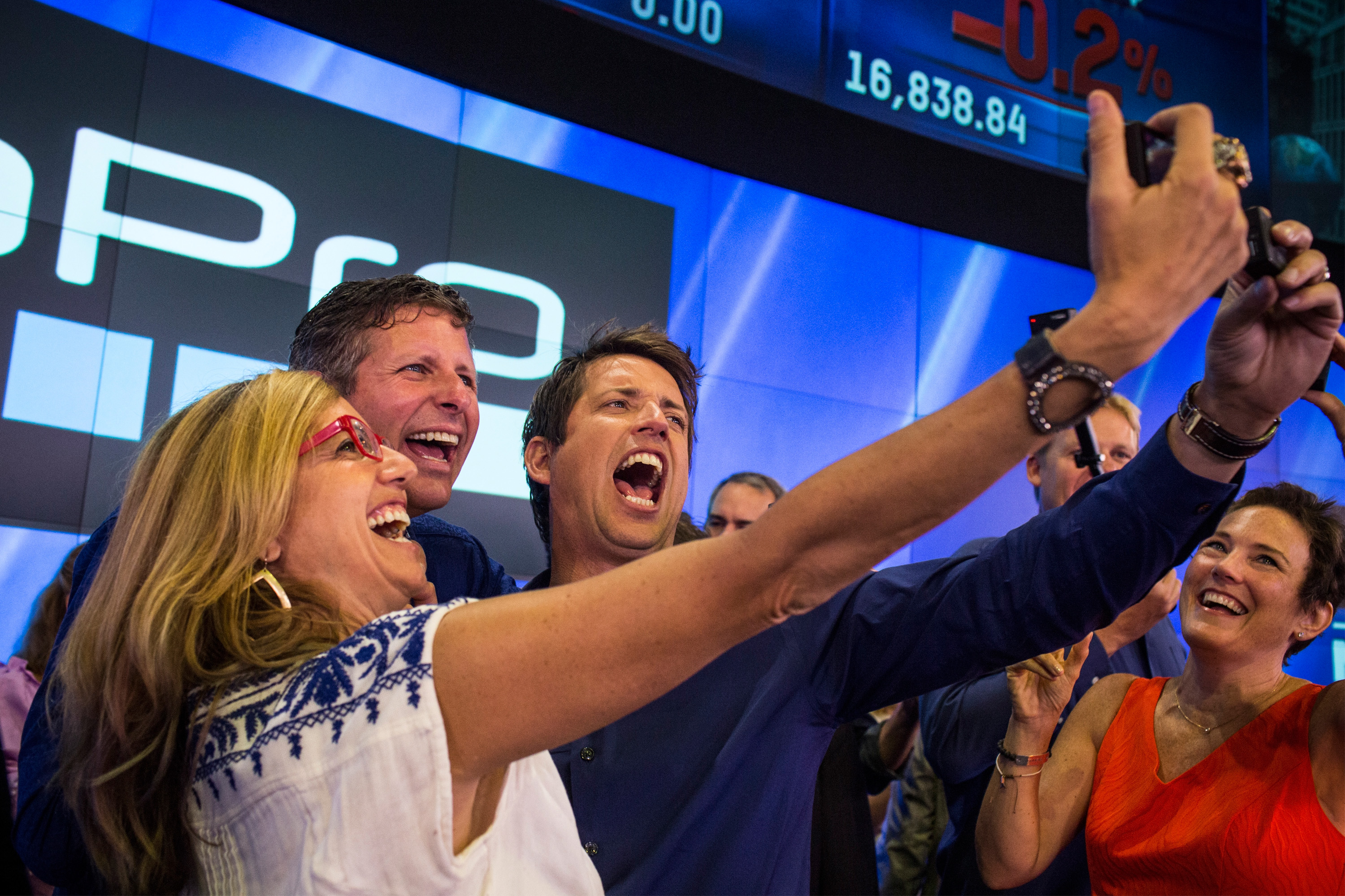 Nick Woodman (R), founder and CEO of GoPro takes a selfie with ...