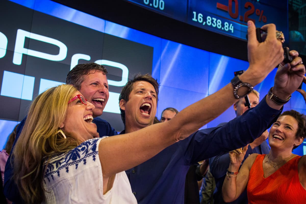 Nick Woodman (R), founder and CEO of GoPro takes a selfie with ...