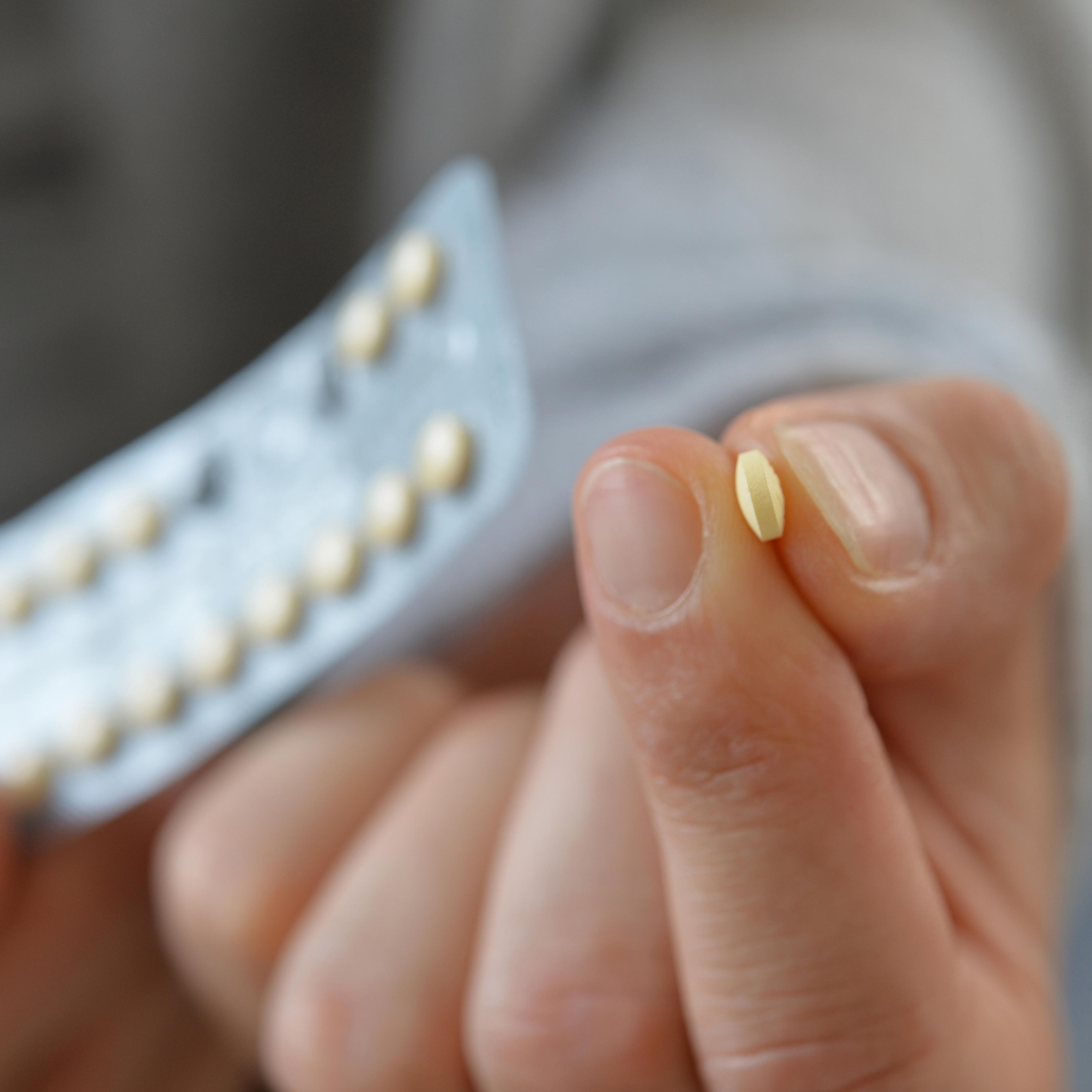Woman taking birth controll pill
