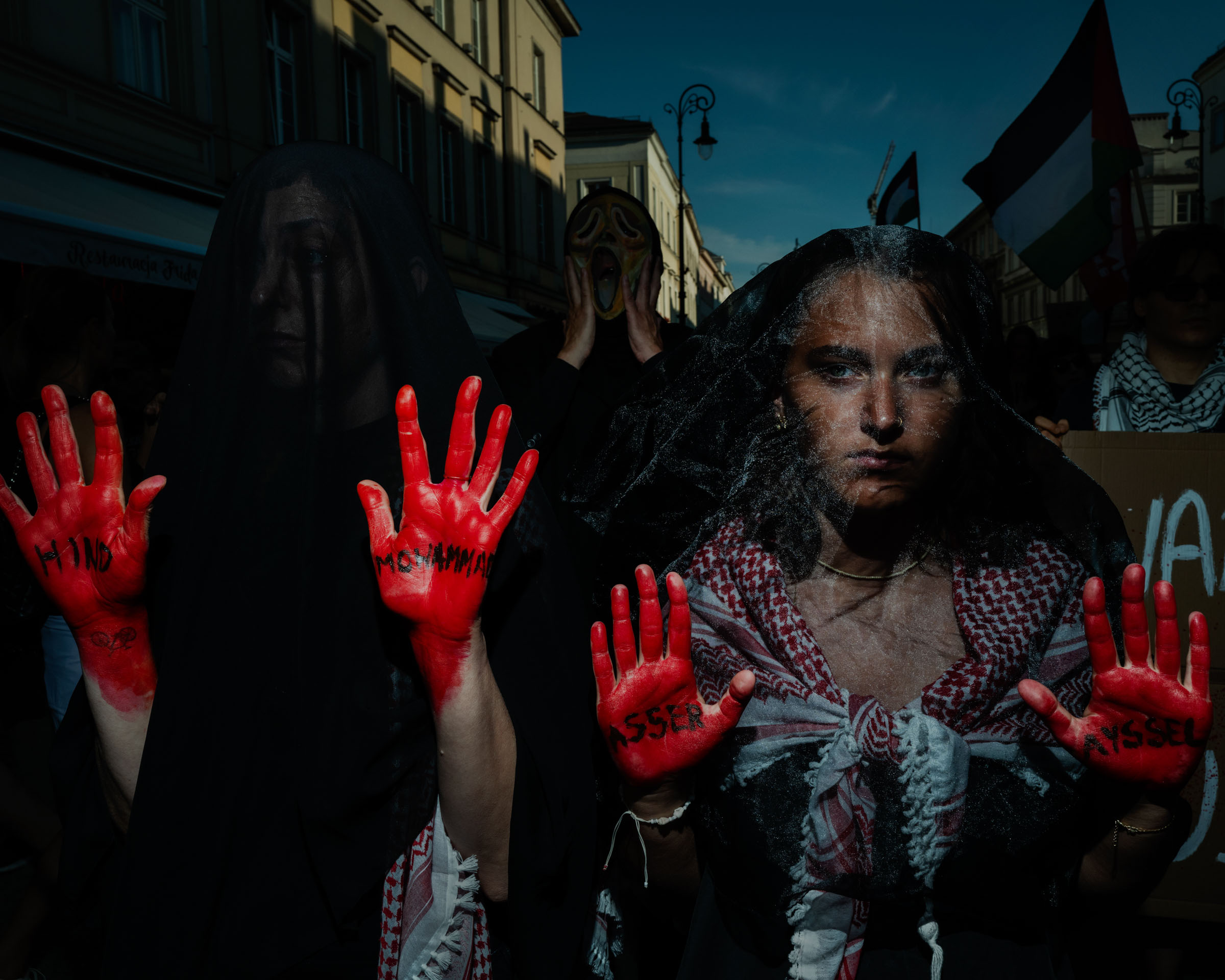 POLAND. Warsaw. 01 September 2024. Silence March in memory of the victims of genocide in Gaza strip. Protresters with names of killed Palestinians  on the palms of their hands