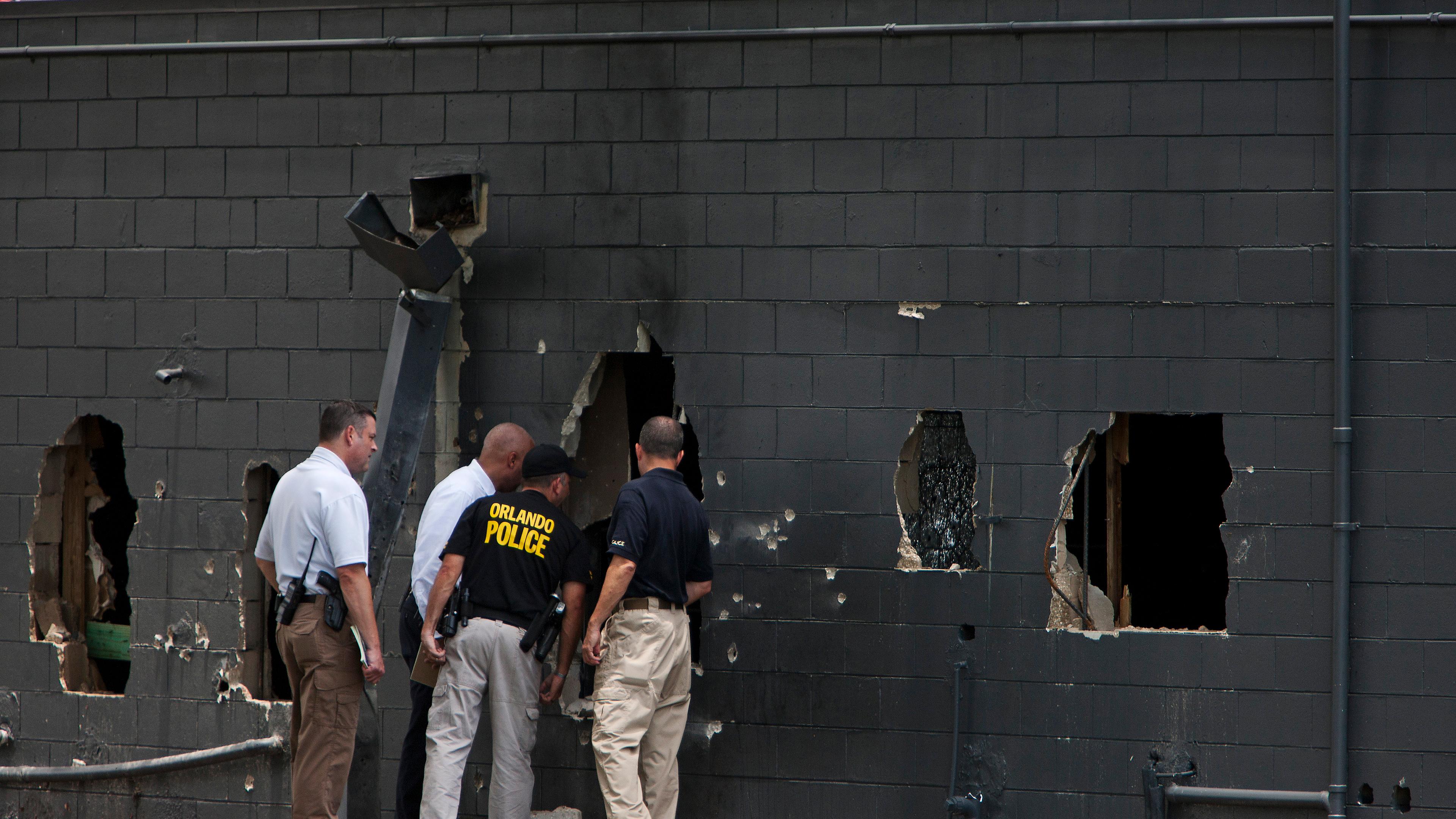 Police investigate the Pulse nightclub following a mass shooting in Orlando, Fla., on June 12, 2016.