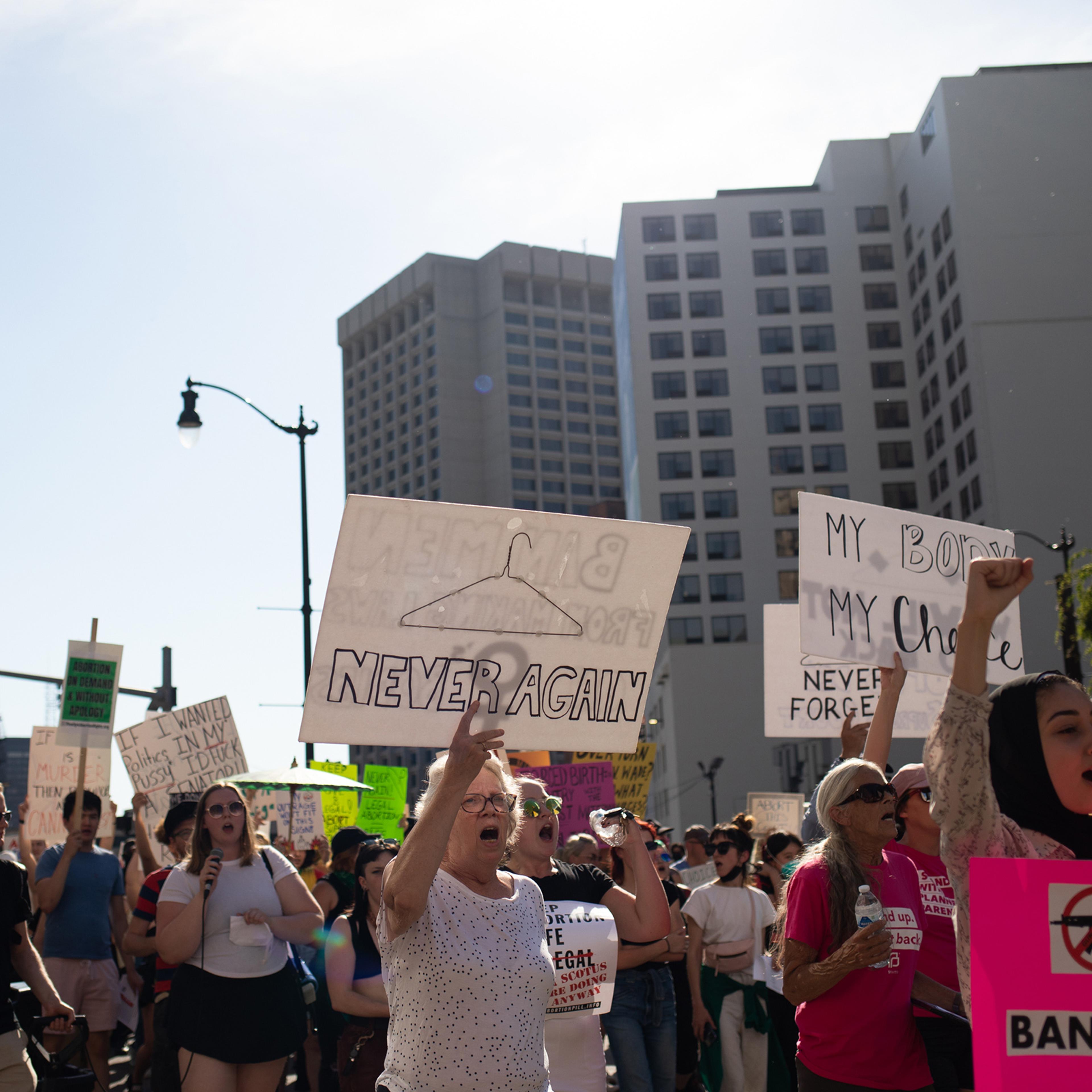 Abortion rights demonstrators march through the streets to protest the Supreme Court's decision in the Dobbs v. Jackson Women's Health case on June 24 in Detroit, Mich.