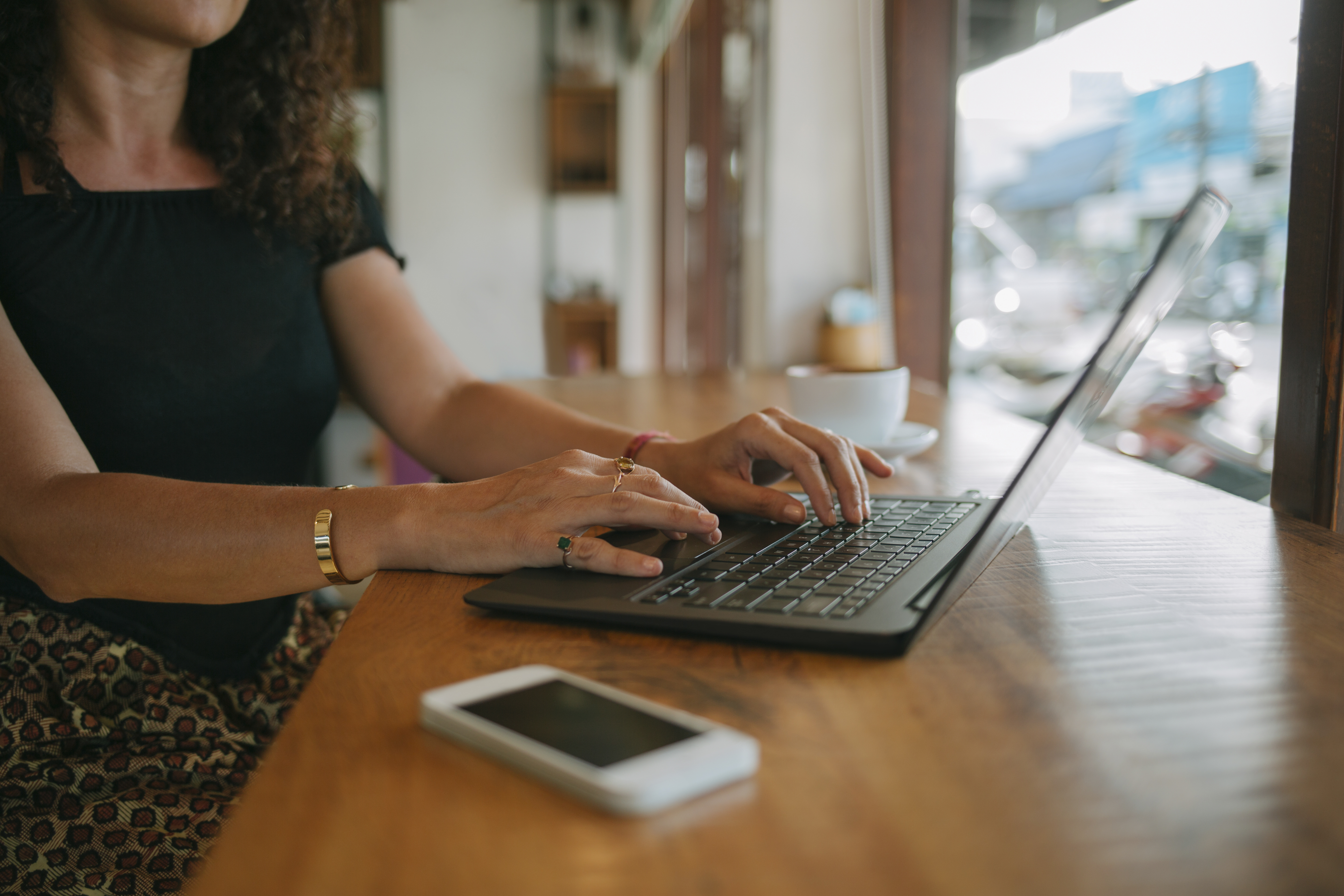 Woman using laptop in a cafe