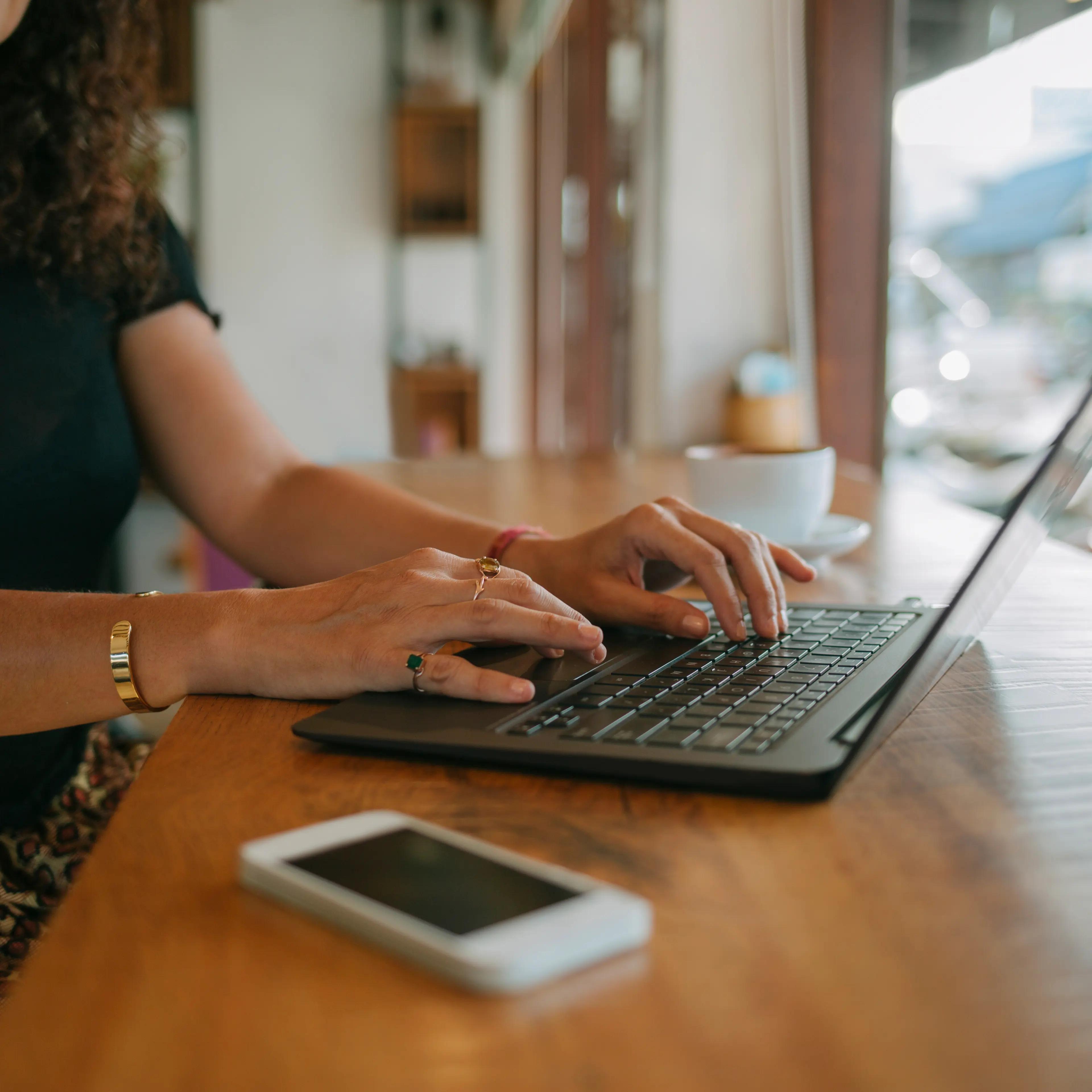 Woman using laptop in a cafe