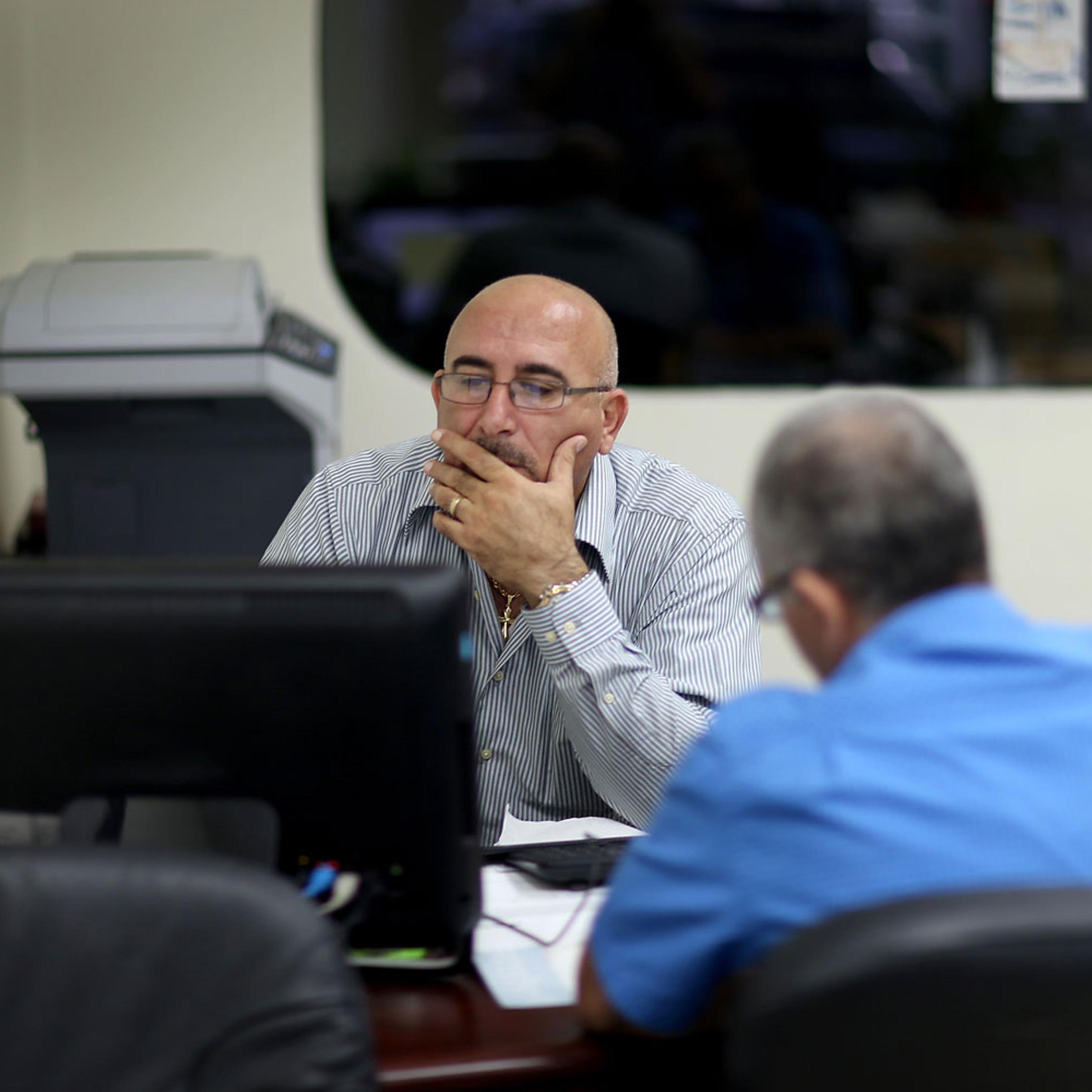 A. Michael Khoury at Leading Insurance Agency enrolls Hisham Uadadeh in a health insurance plan under the Affordable Care Act on Feb. 13, 2014 in Miami.