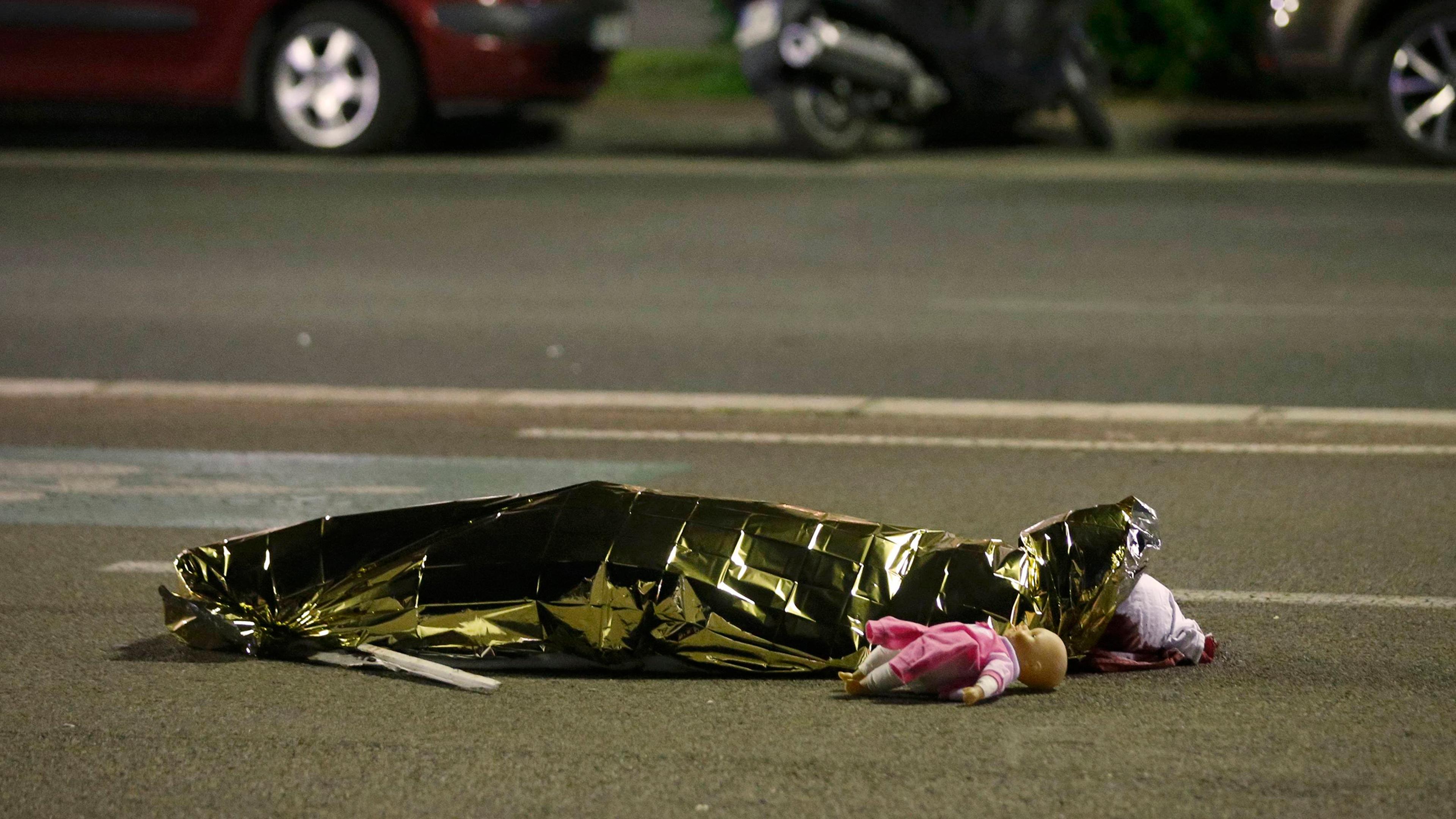 A body is seen on the ground on July 15, 2016, after at least 70 people were killed in Nice, France, when a truck ran into a crowd celebrating Bastille Day.