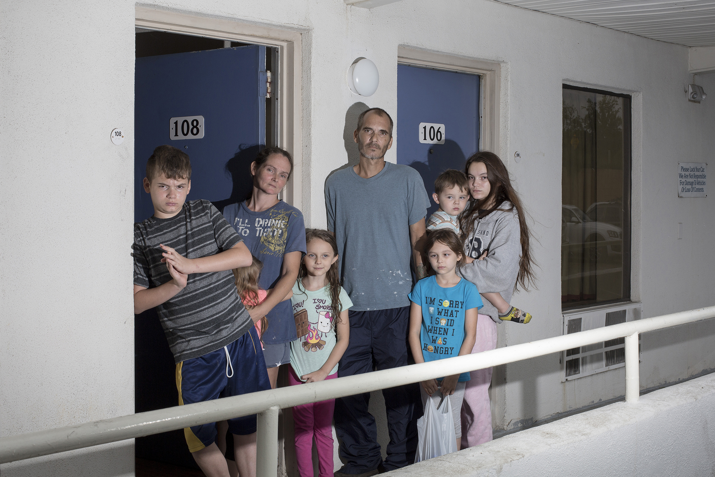 The Brown family from Jacksonville, N.C., poses for a portrait at a motel after fleeing Hurricane Florence in Cary, N.C. on Sept. 14, 2018.