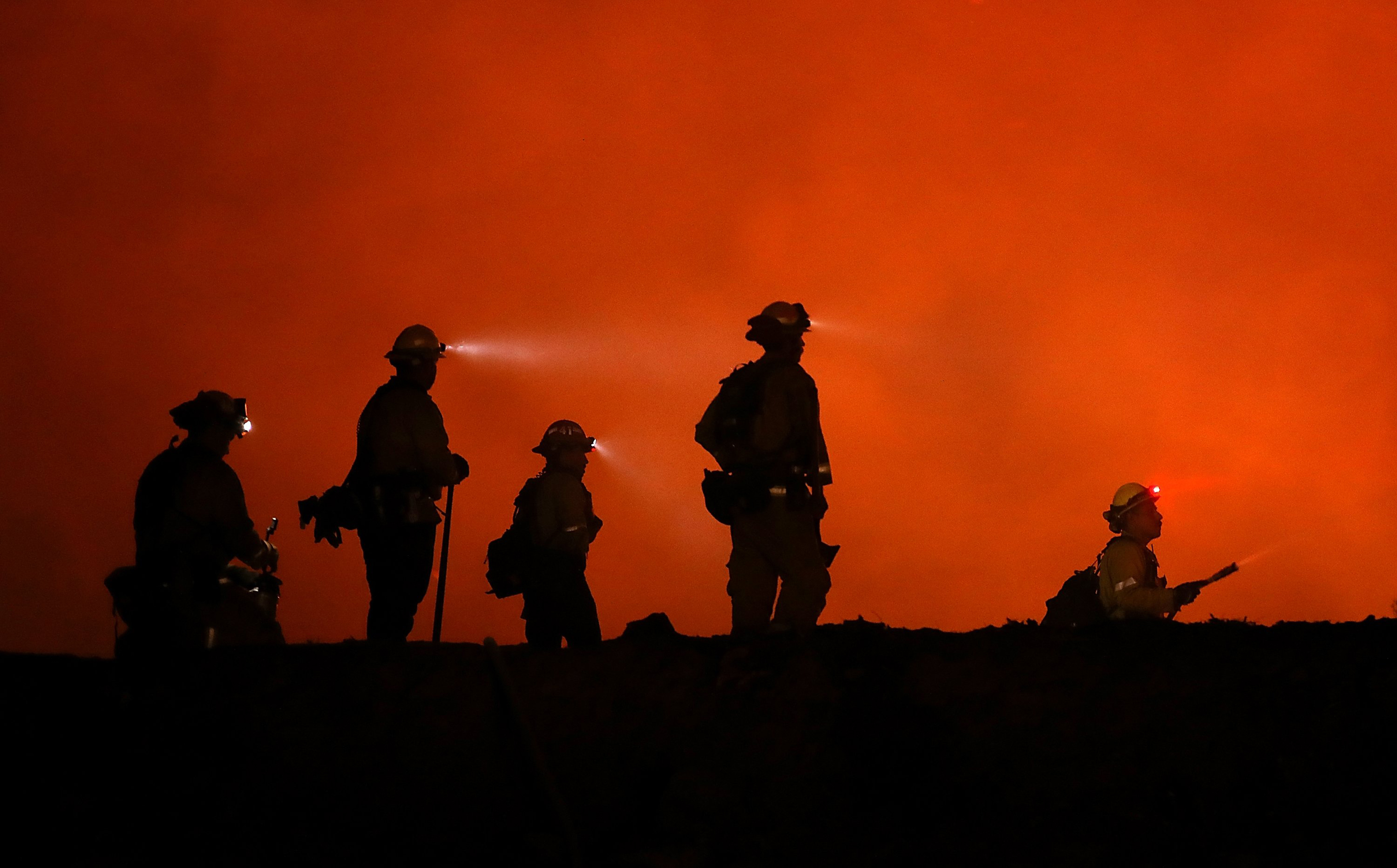 Cal Fire firefighters monitor a back fire as they battle the Medocino Complex fire near Lodoga, Calif. on Aug. 7, 2018.
