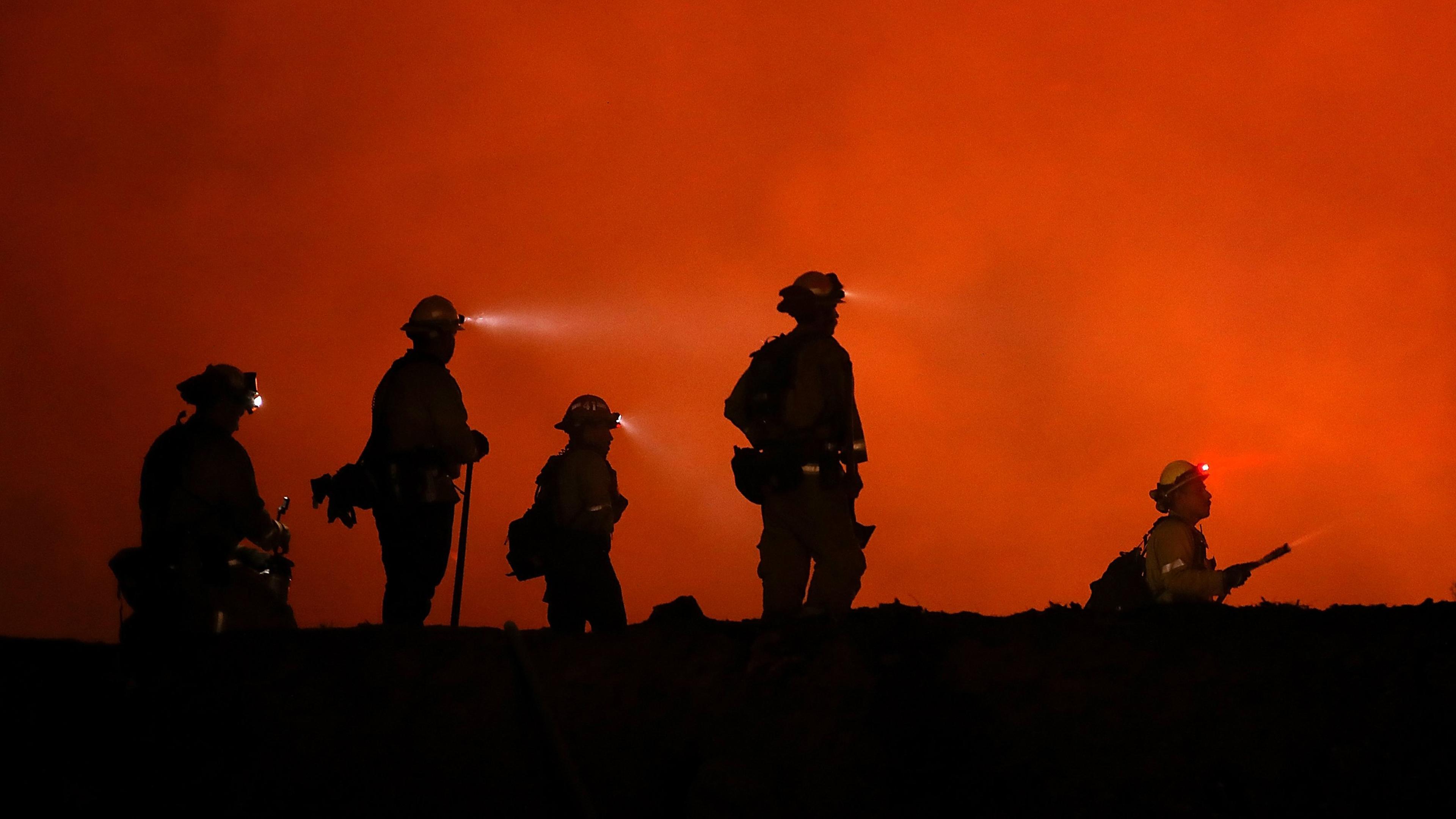 Cal Fire firefighters monitor a back fire as they battle the Medocino Complex fire near Lodoga, Calif. on Aug. 7, 2018.