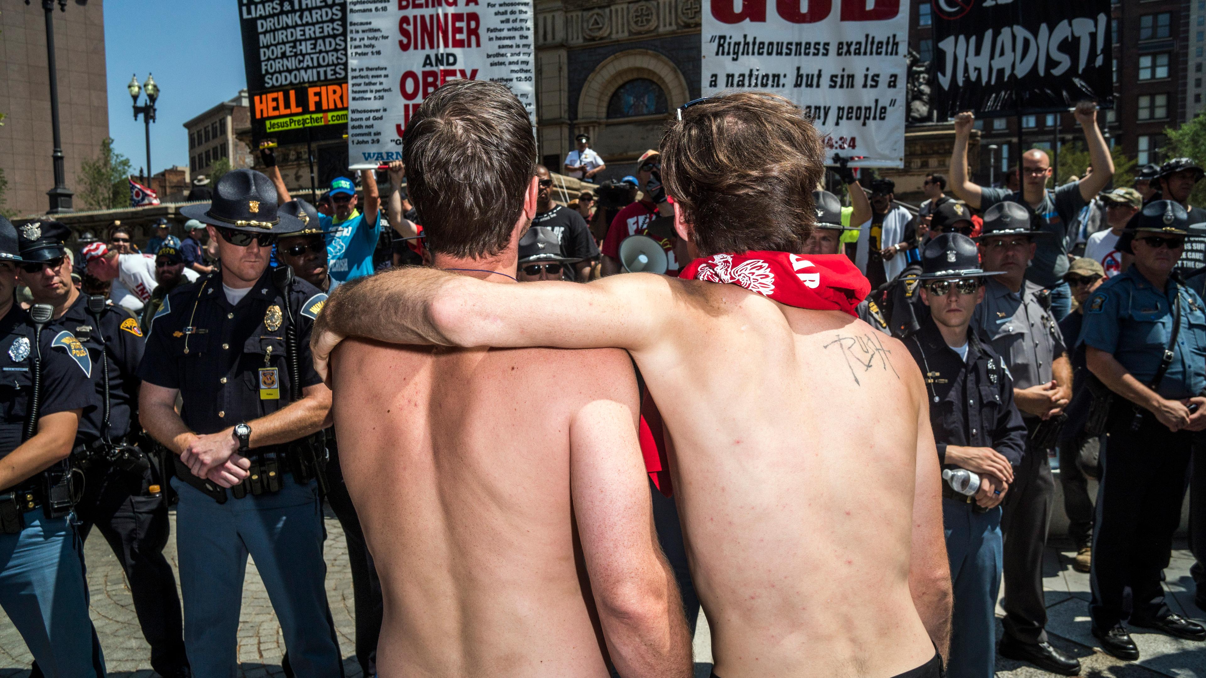 A pair of men interact with protesters in the Cleveland Public Square at the Republican National Convention in Cleveland on Tuesday, July 19, 2016.
