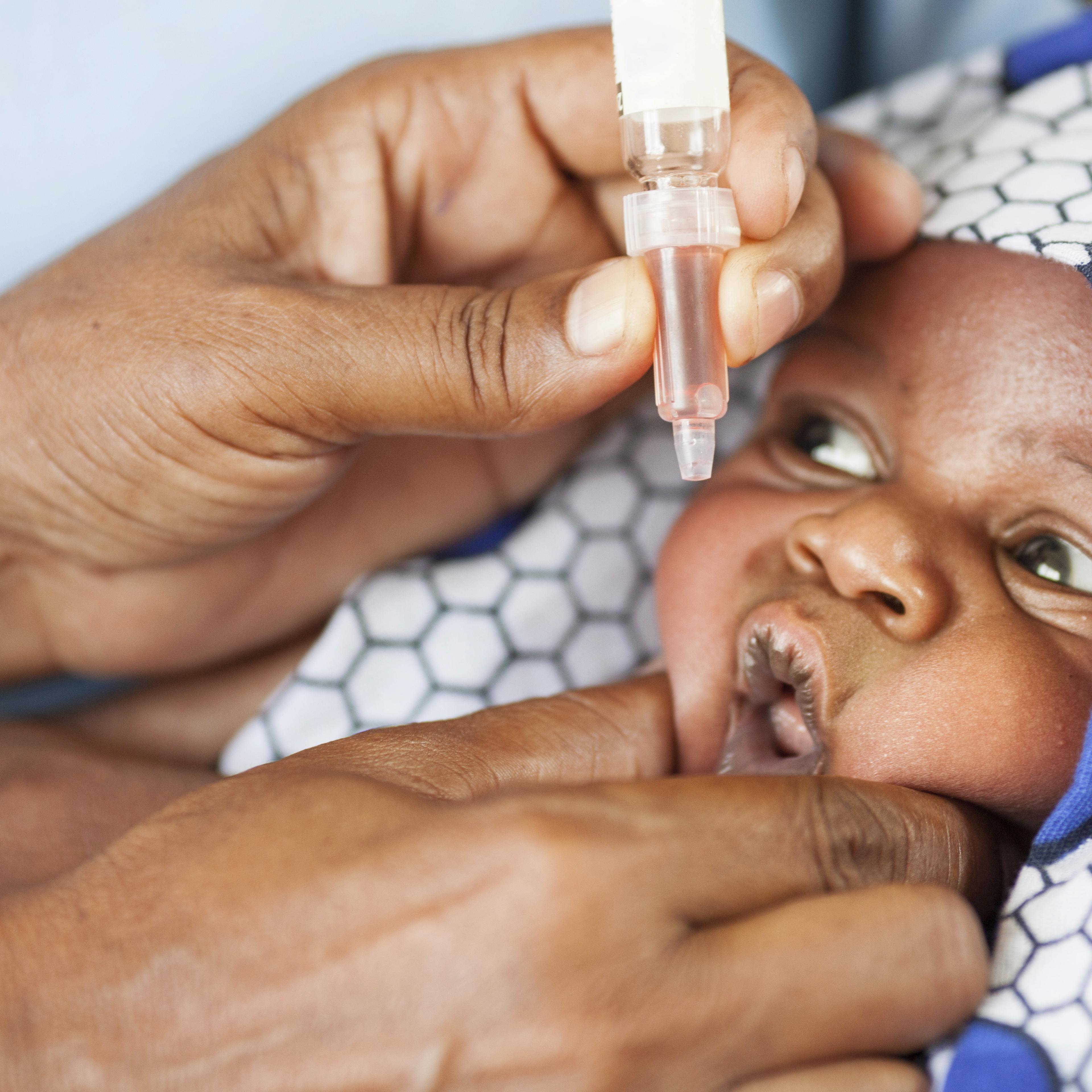 Safe baby: a child in Africa receives an oral vaccine