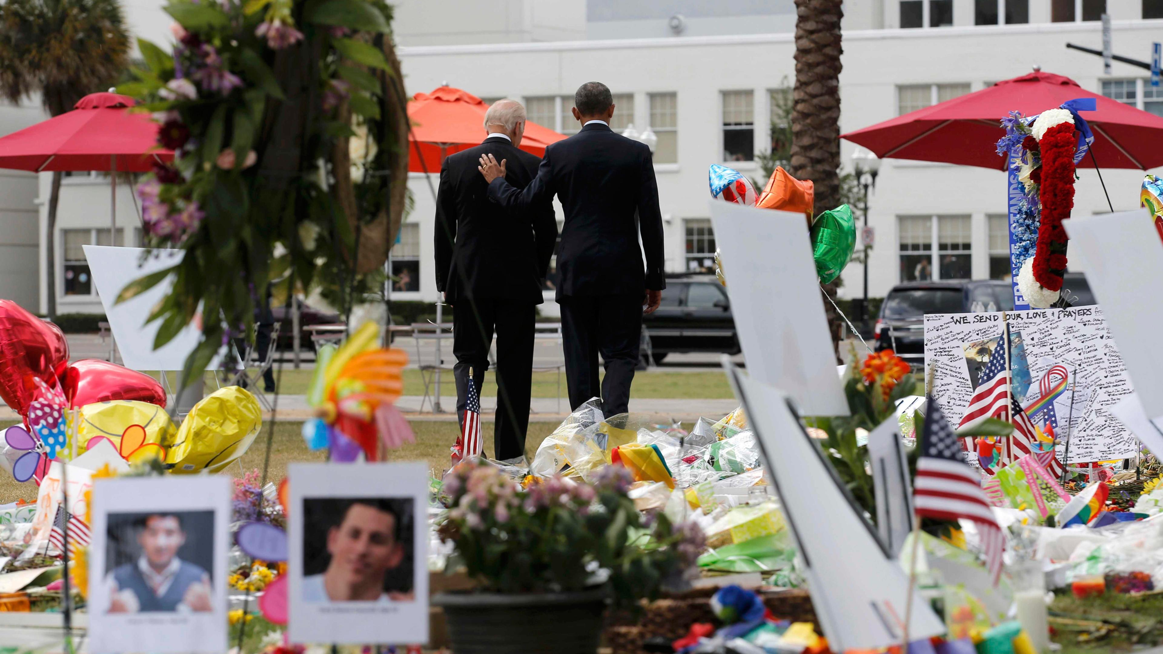 U.S. President Barack Obama (R) and Vice President Joe Biden depart a makeshift memorial after placing flowers in memory of shooting victims of the massacre at a gay nightclub in Orlando, Florida, U.S., June 16, 2016. REUTERS/Carlos Barria -TPX IMAGES OF