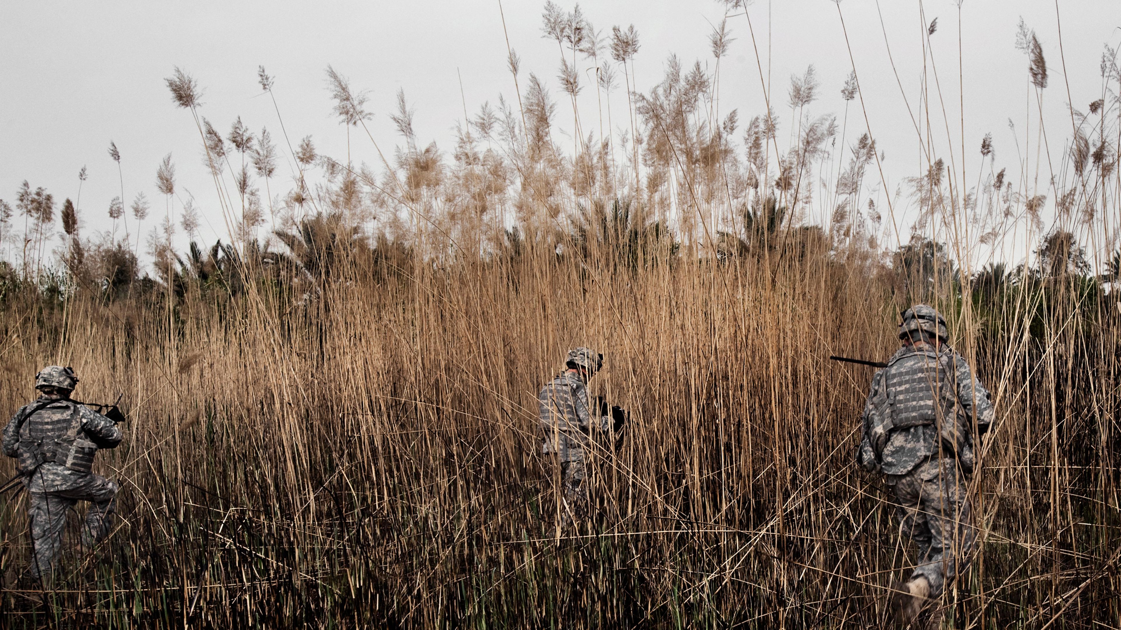U.S. soldiers fan out across an open field near Baquba, searching for a sniper who fired one shot in their direction. Moments before coming under attack, the soldiers discovered a Kalashnikov, a Quran and the makings of a roadside bomb in a hiding place