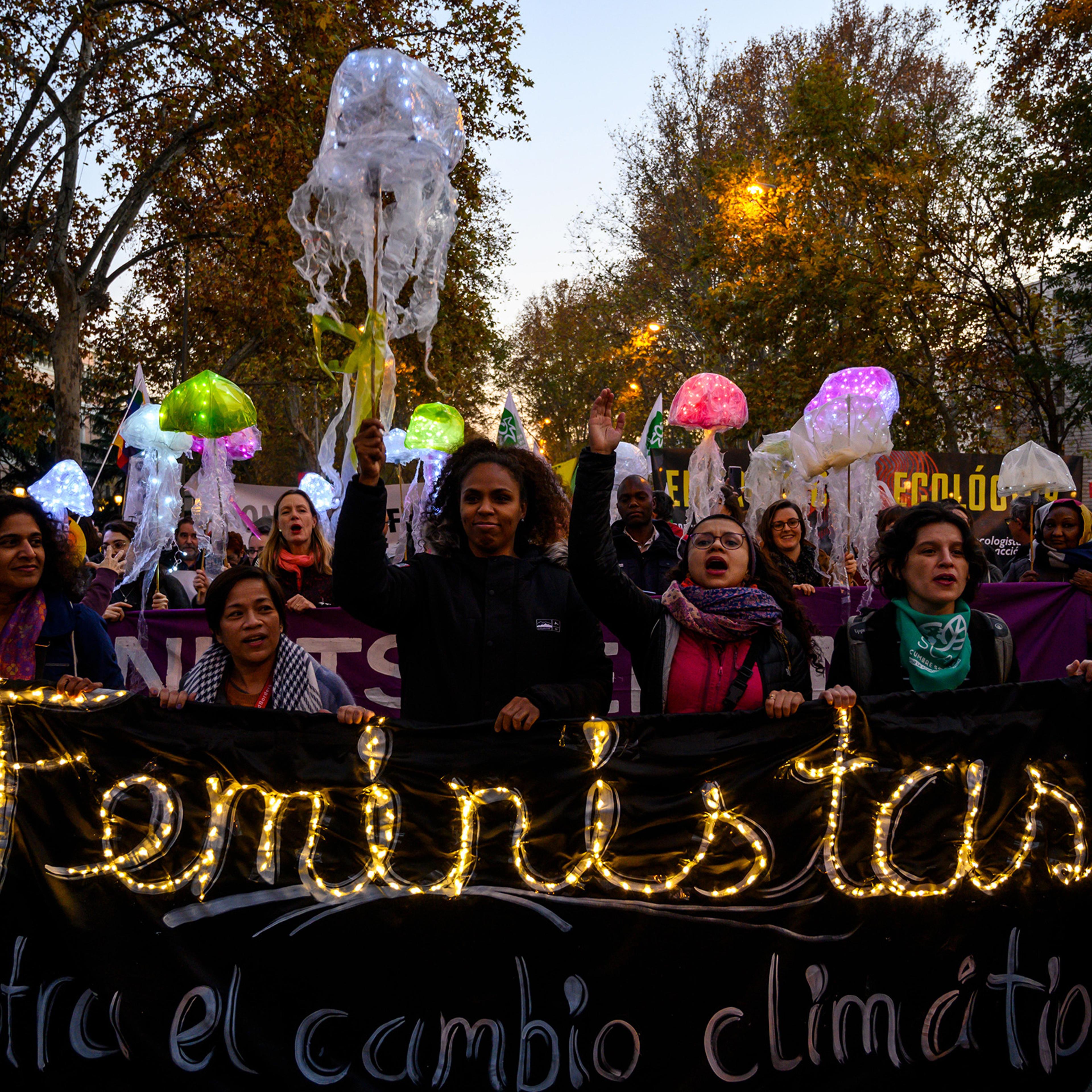 Women hold a banner that reads “Feminists against climate change” at a 2019 protest in Madrid.