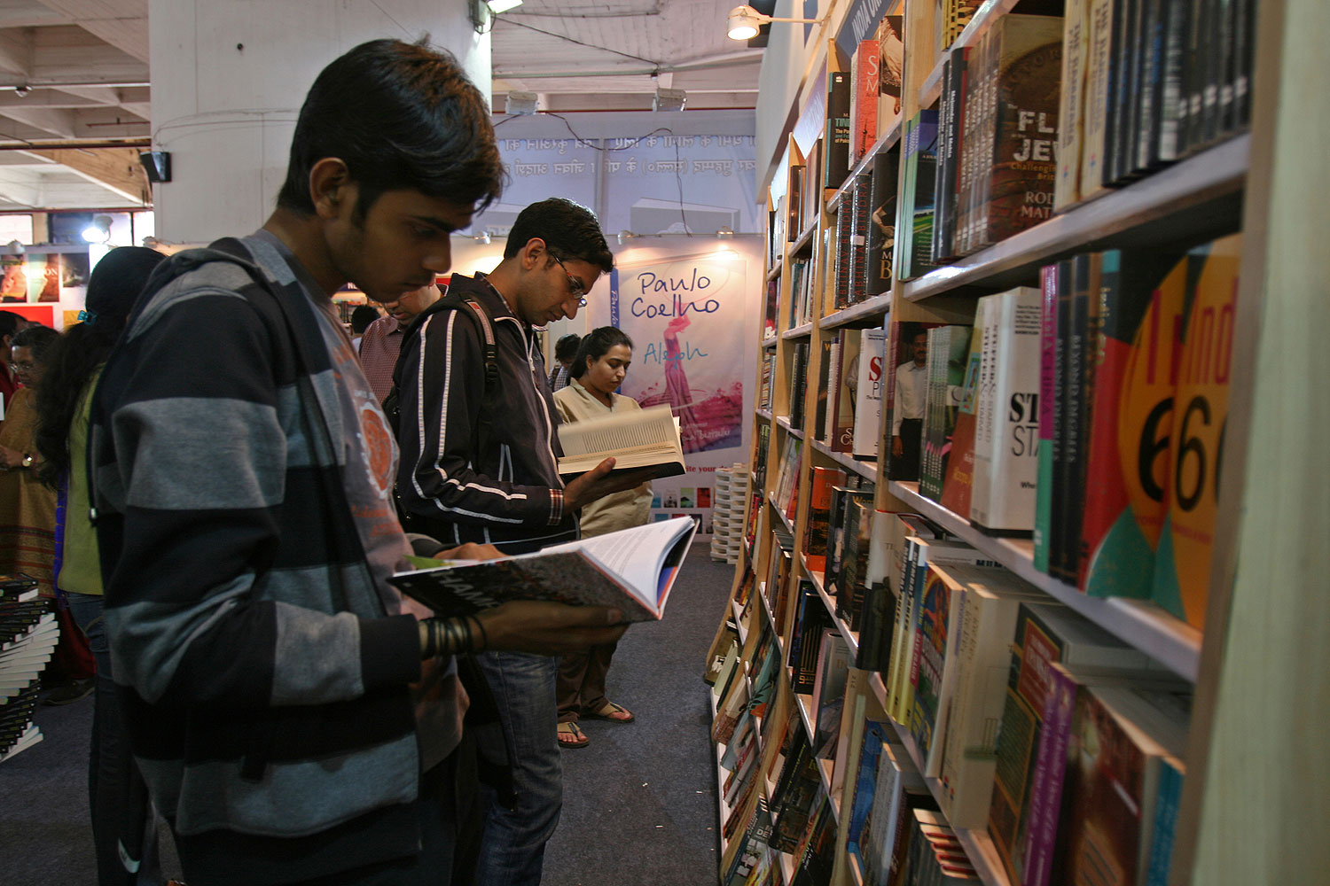 Readers browse through Penguin books in New Delhi. As of today, Wendy Doniger's won't be among them