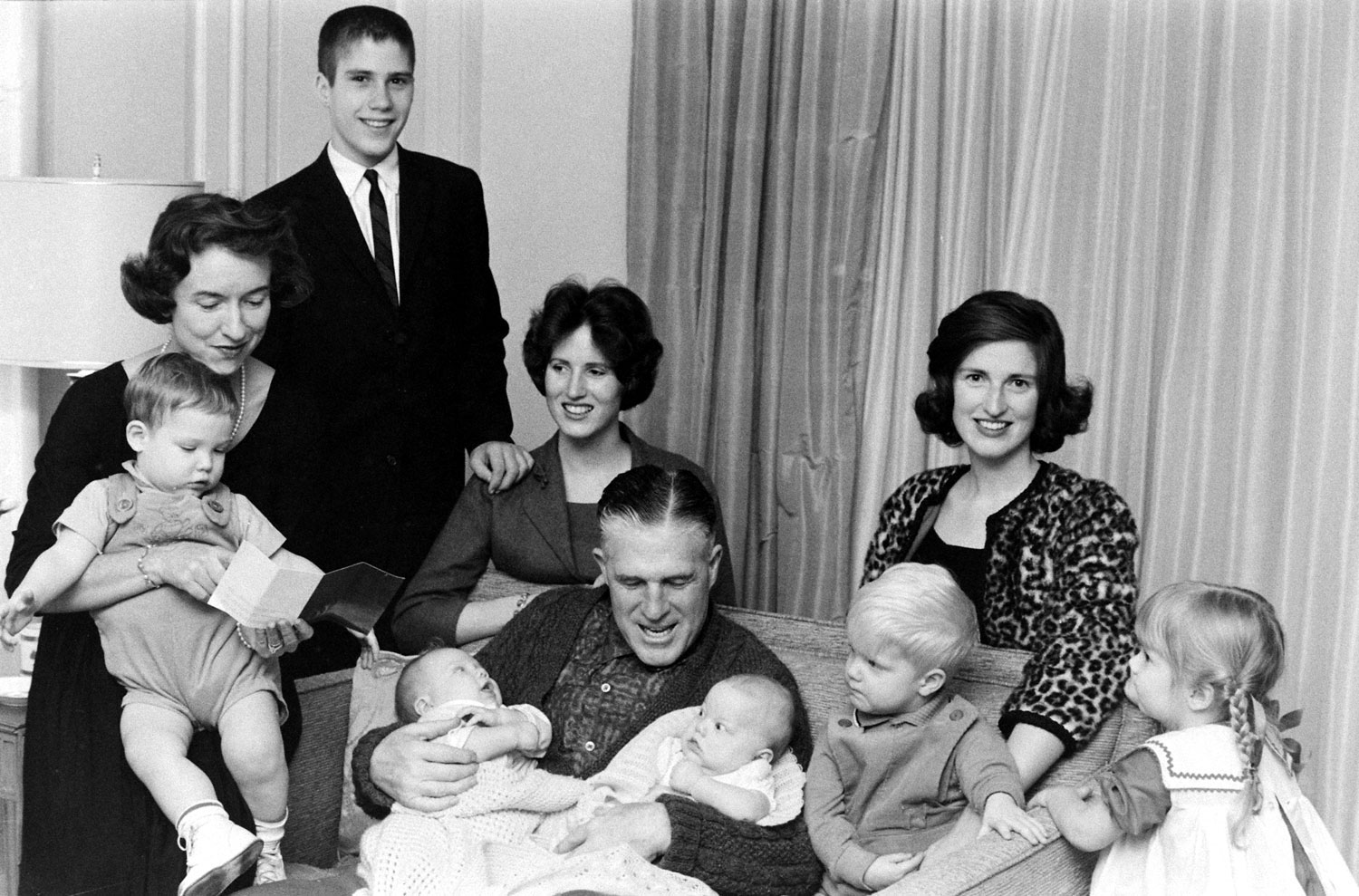 After Sunday services the Romneys crowd onto a sofa in living room. Son Mitt and married daughters Jane and Lynn are at the rear. From left, grandchildren are Gregory (held by Lenore), Douglas, Susan, Brett and Jody. Another son, Scott, is in England wit