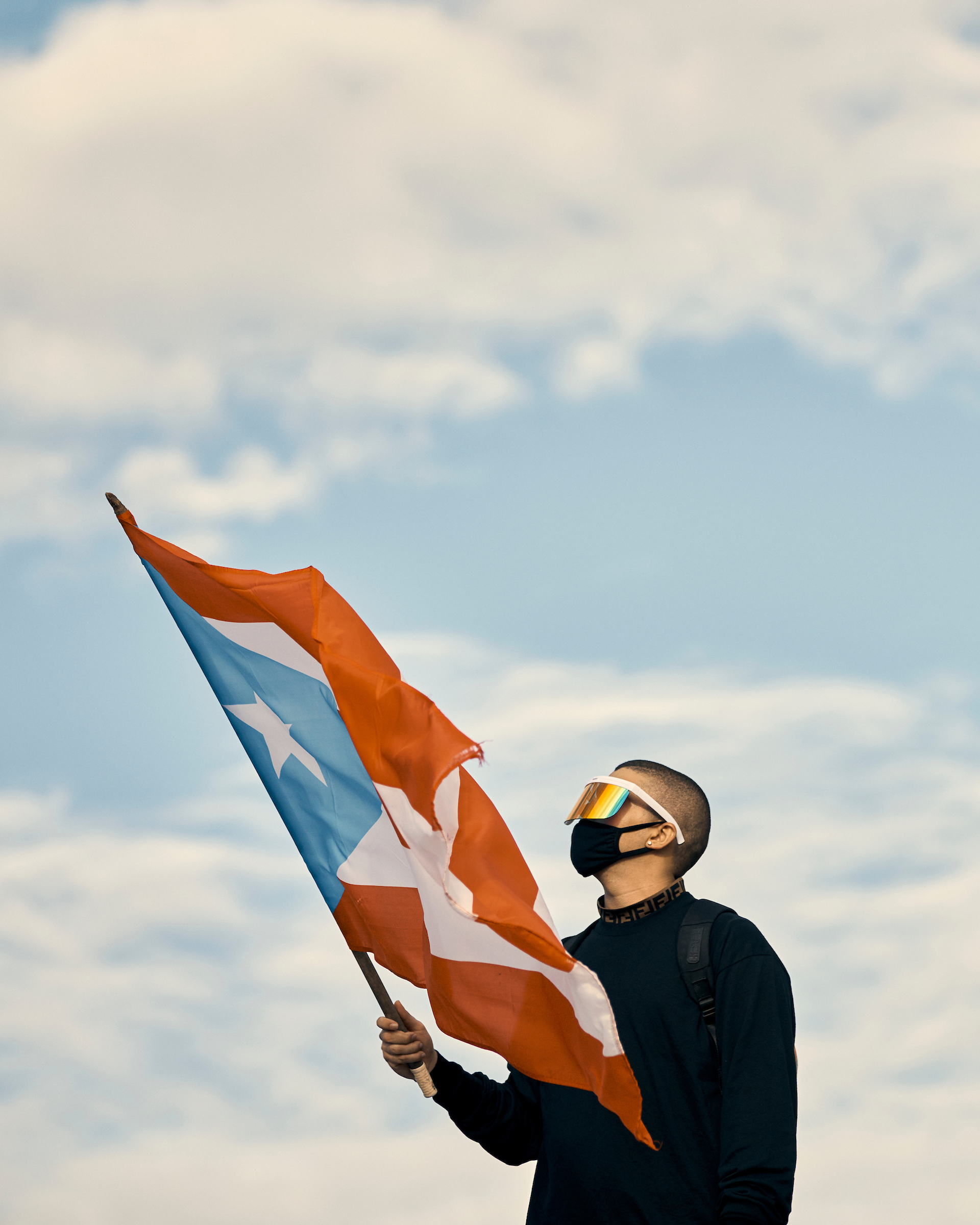 Bad Bunny waves a flag at the anti-Rosselló protest in San Juan, Puerto Rico, on July 17, 2019.