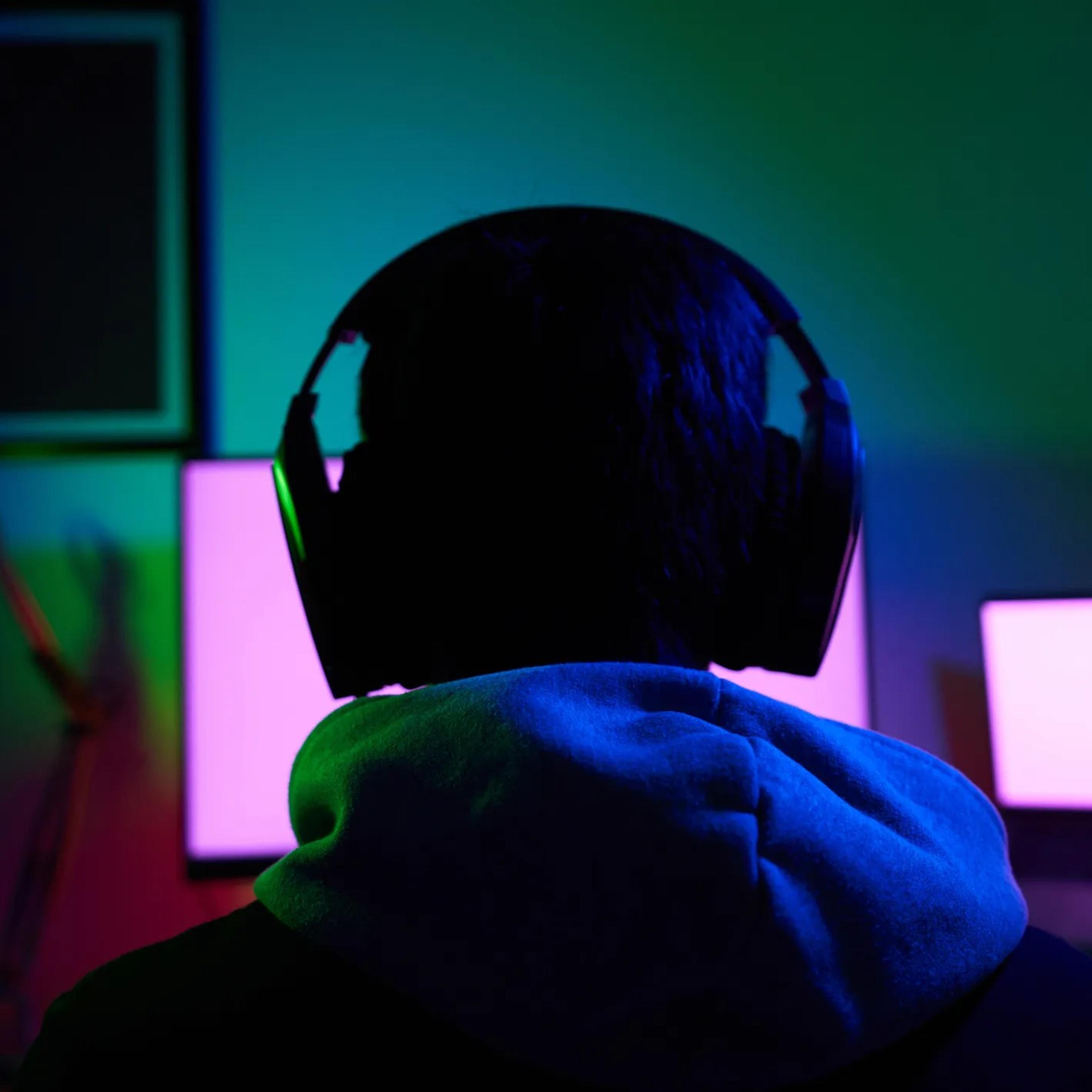 Young man wearing headset and play computer video games online