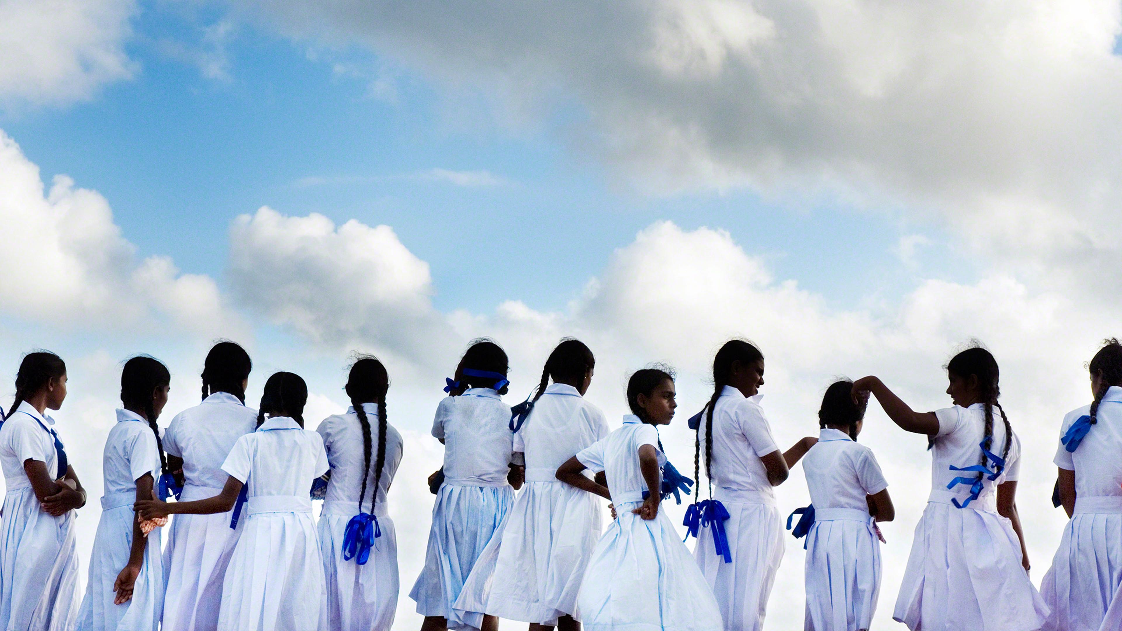 School girls looking out to sea in Galle Port, Sri Lanka.