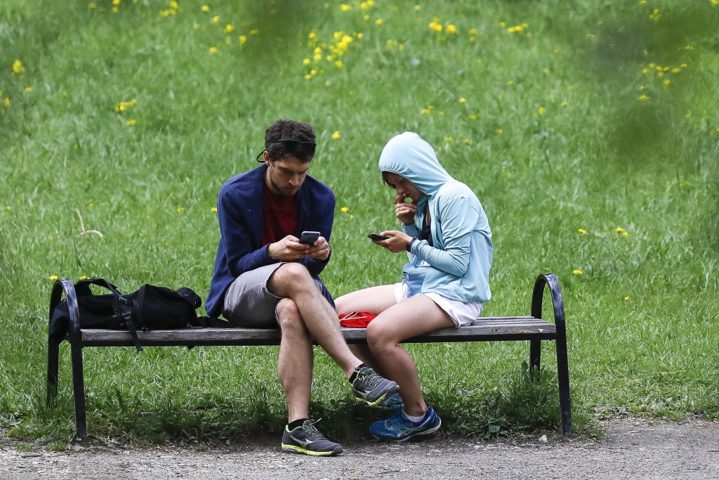 Couple on smartphones ignoring each other.