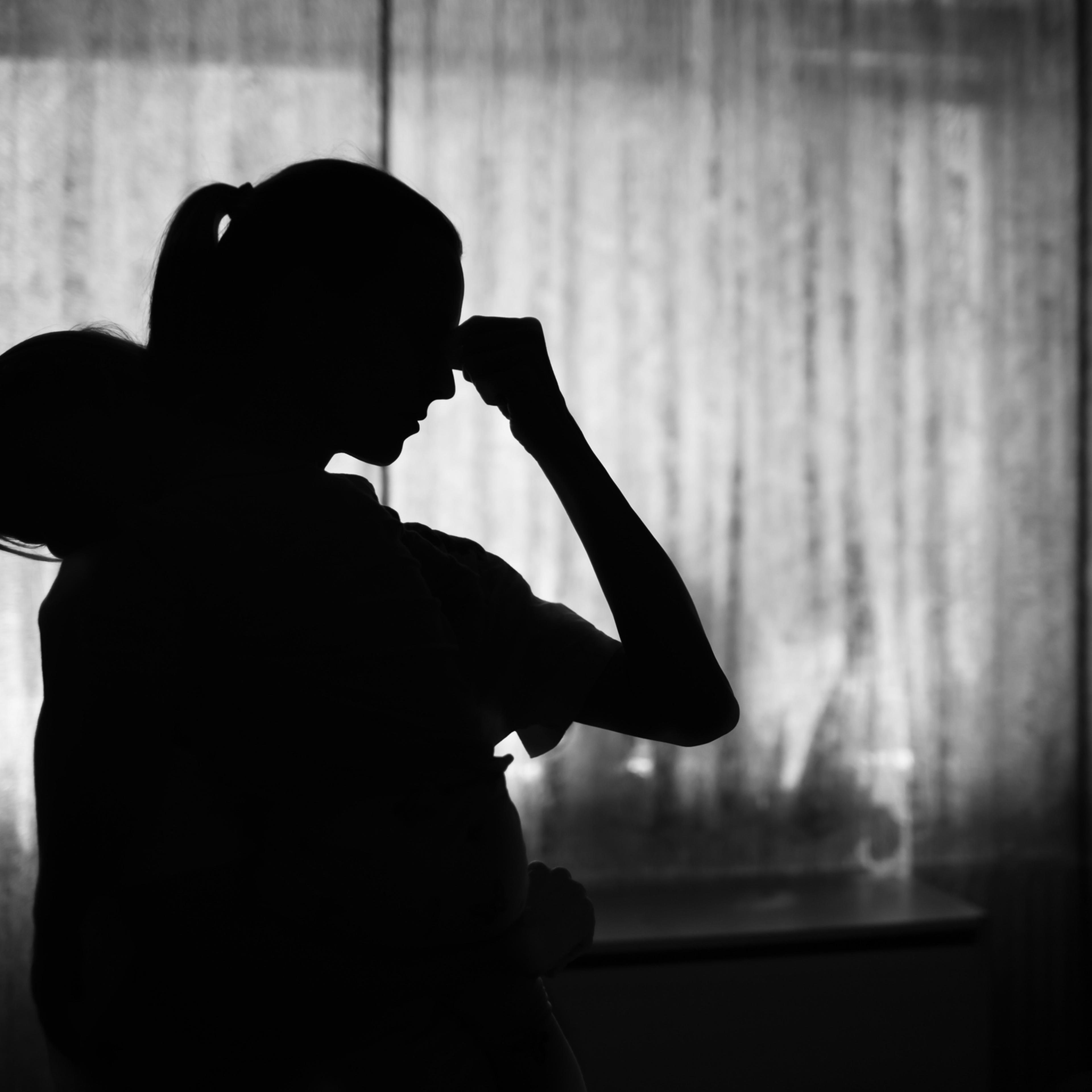 Exausted tired mother at home taking care of baby