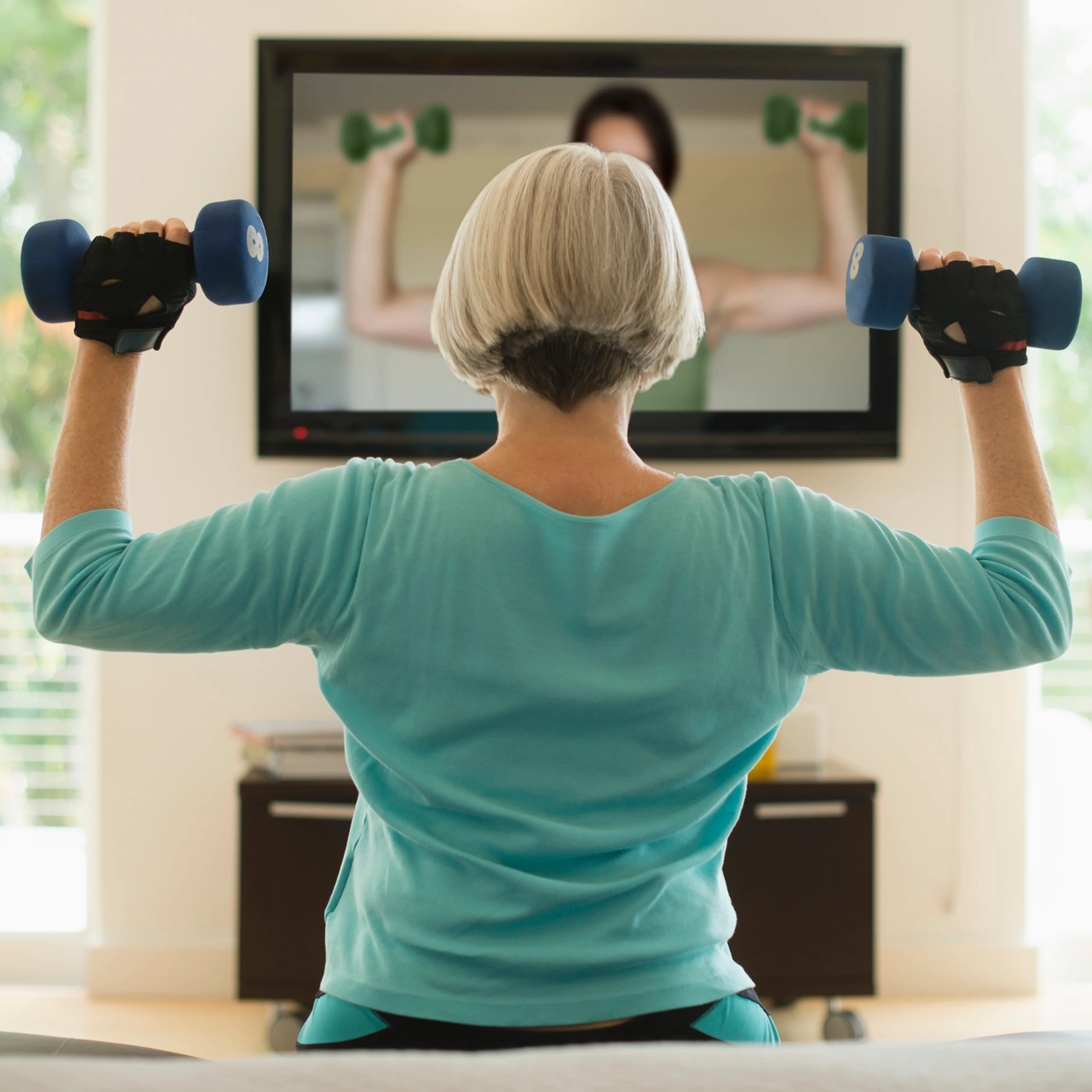 Caucasian woman exercising with hand weights