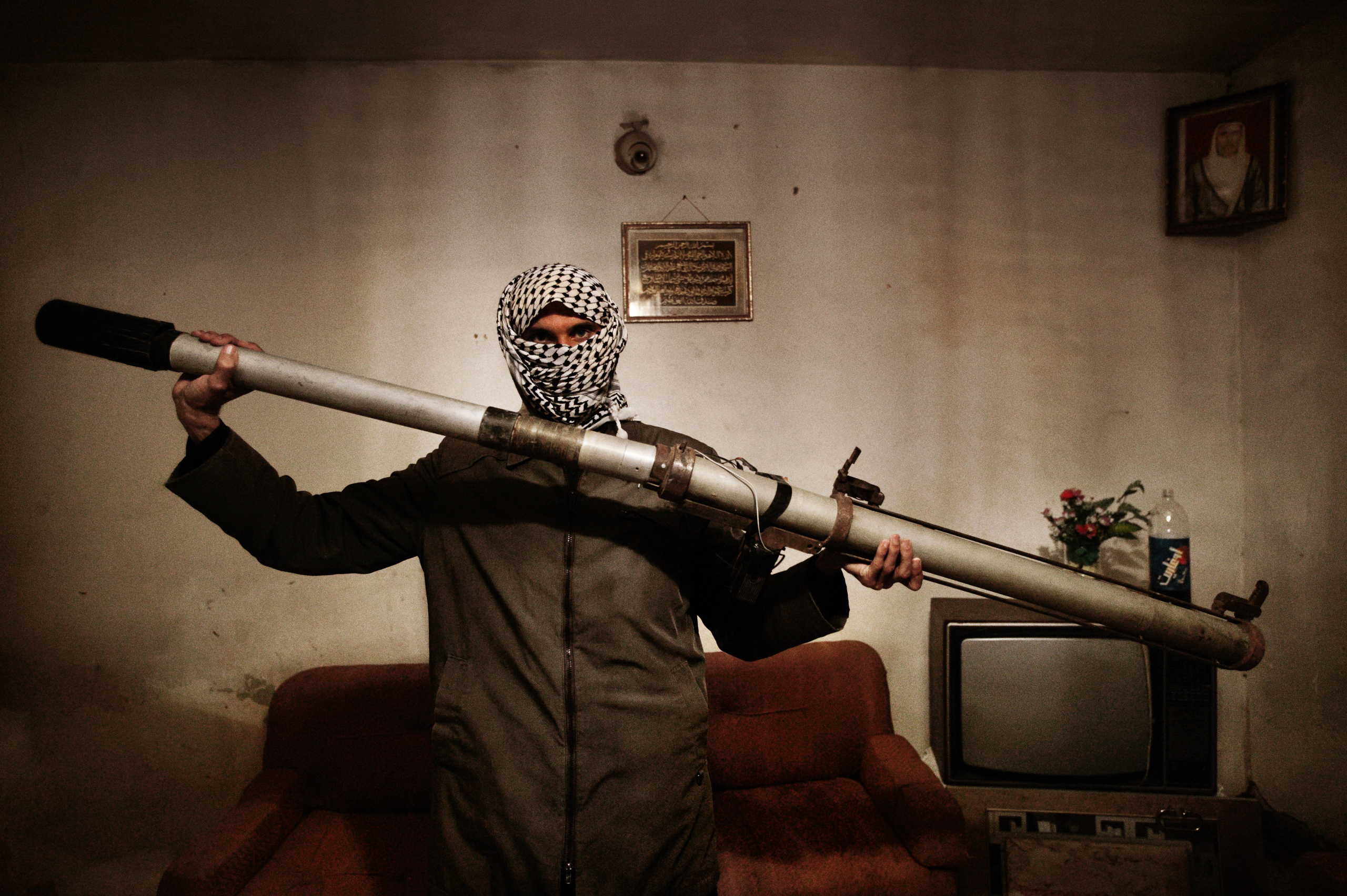 A member of a resistance network operating against U.S. forces in Iraq holds a modified launcher for surface-to-air missiles, Baghdad, Iraq, Dec. 4, 2003.