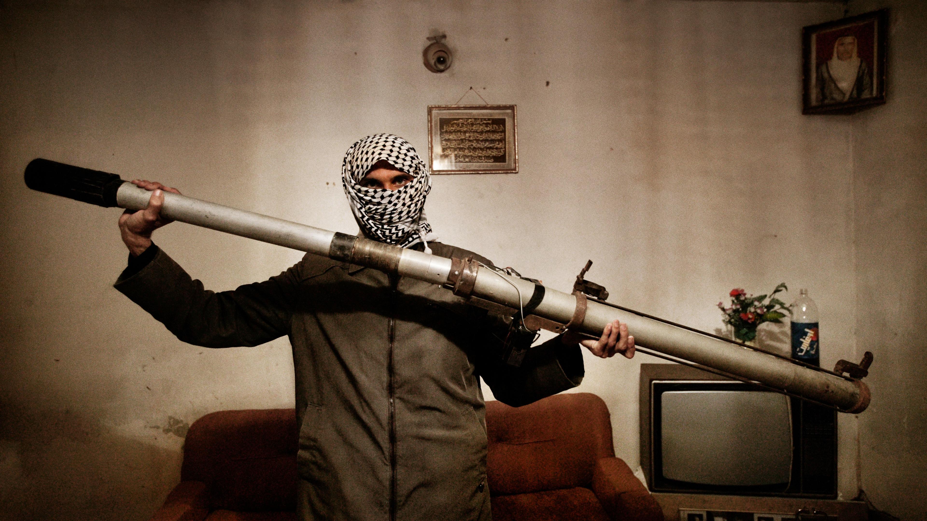 A member of a resistance network operating against U.S. forces in Iraq holds a modified launcher for surface-to-air missiles, Baghdad, Iraq, Dec. 4, 2003.